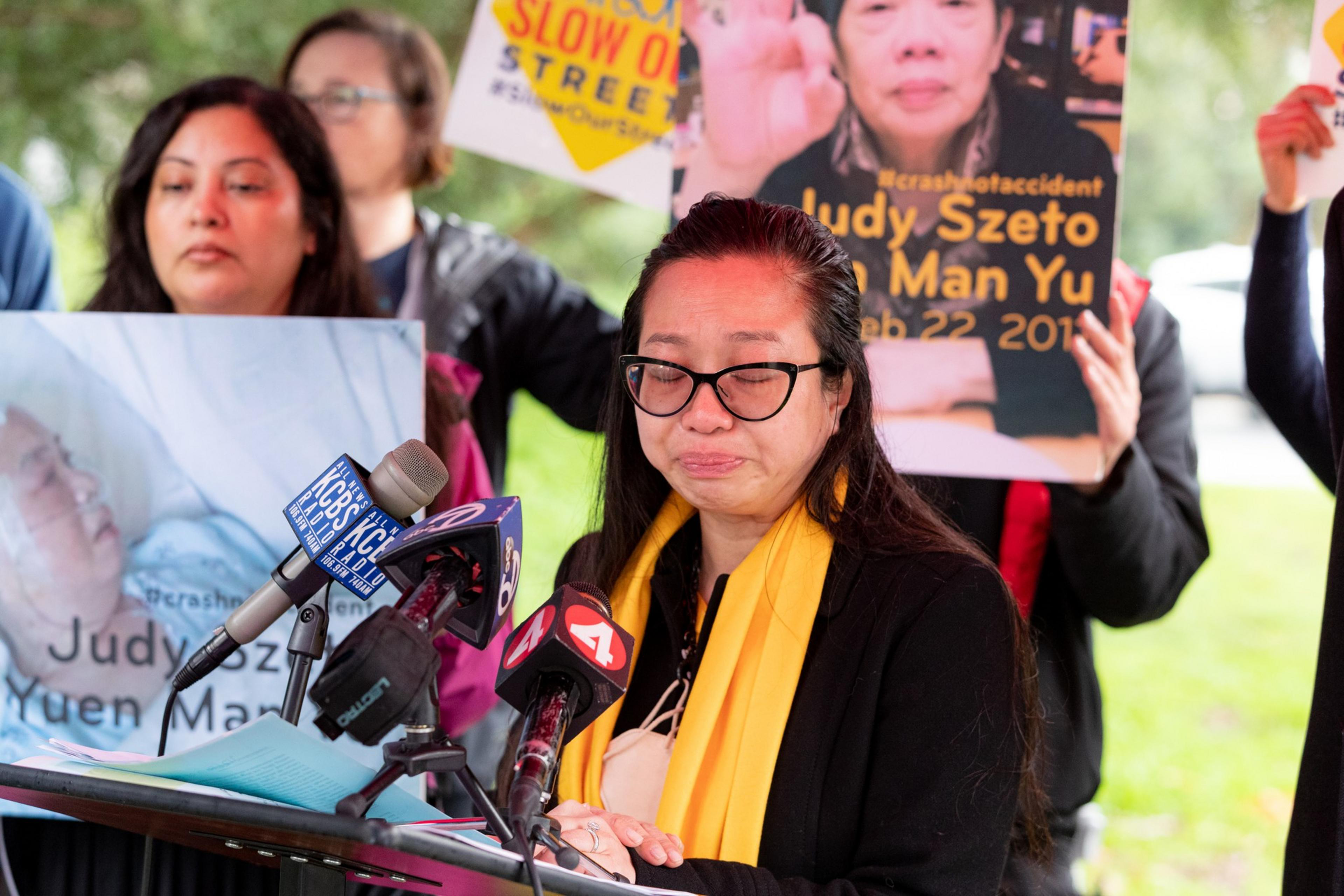 A woman stands at a podium.