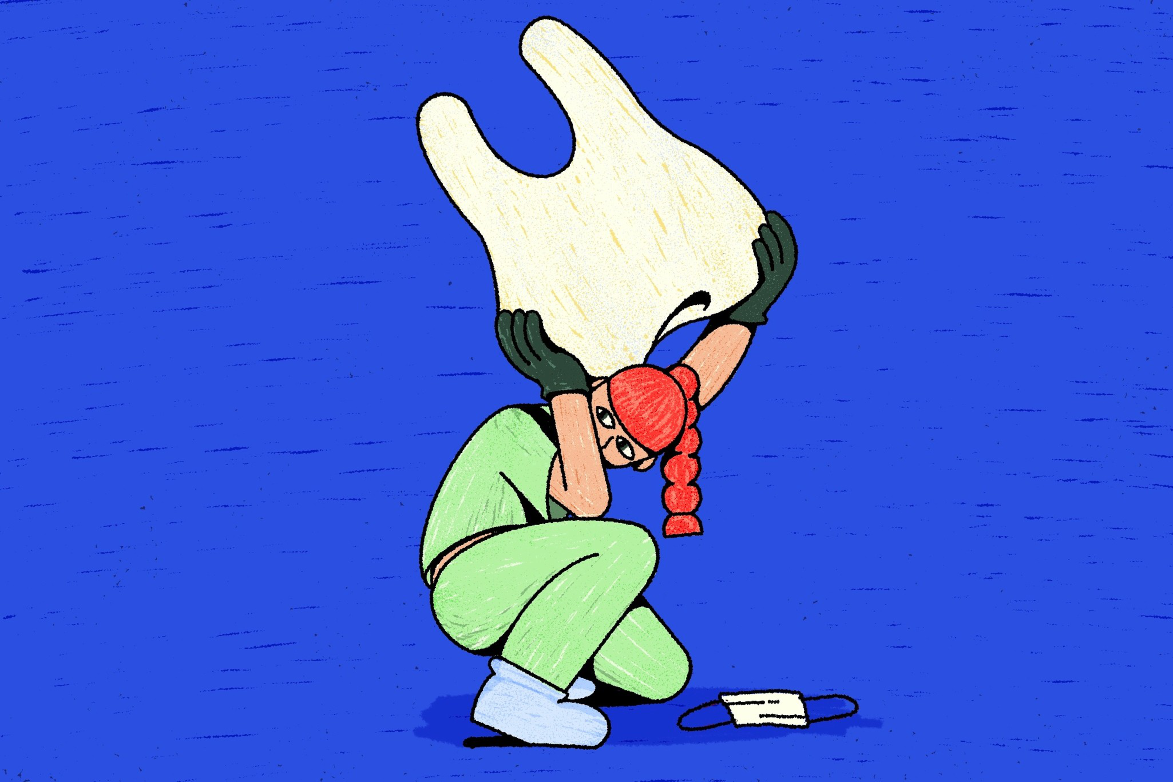 A person in scrubs, gloves, and a red cap crouches, lifting a large white face mask above their head while another mask lies on the ground.