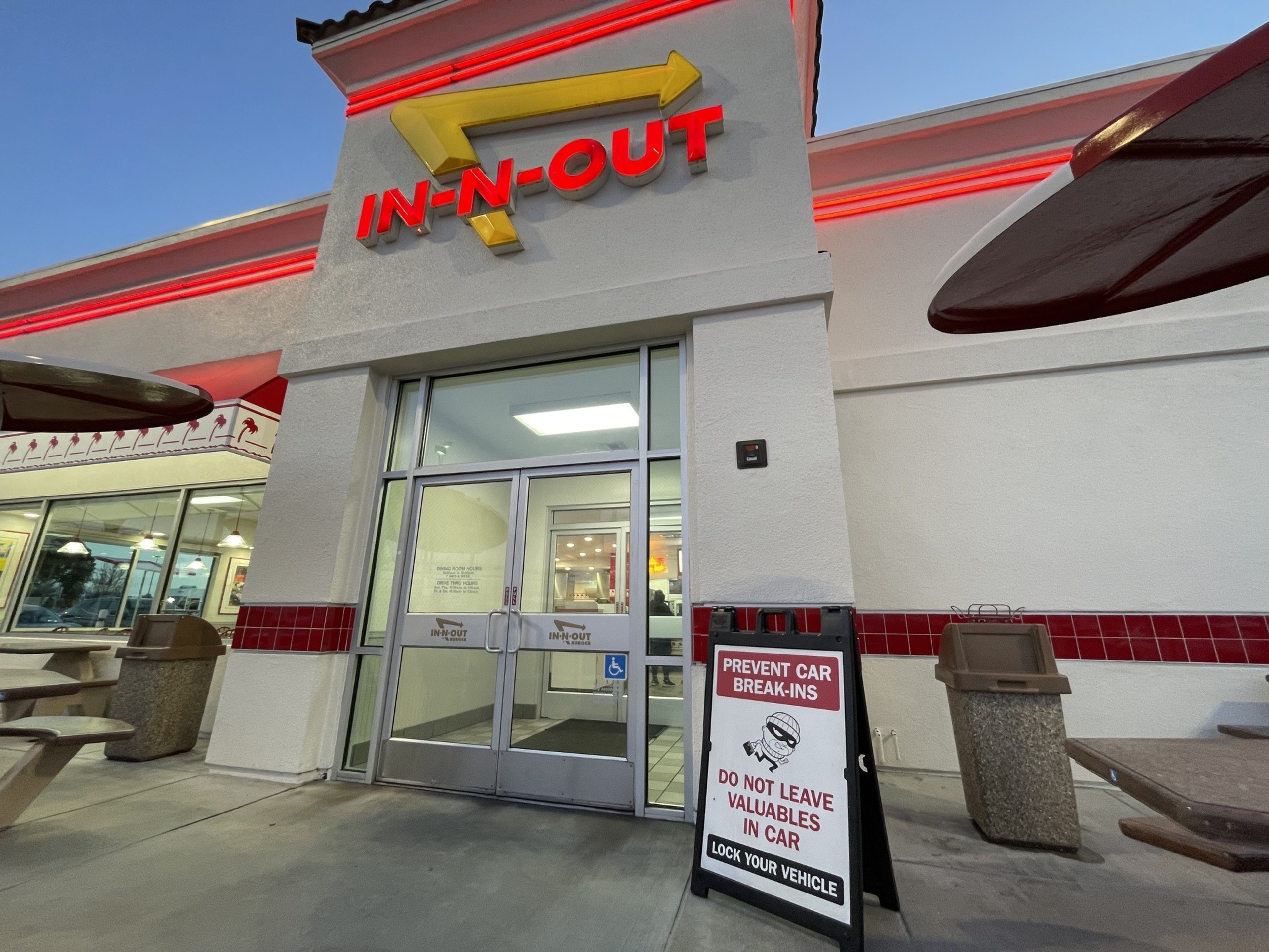A sign warning people of car break-ins is posted if front of an Oakland In-Out-Burger location.