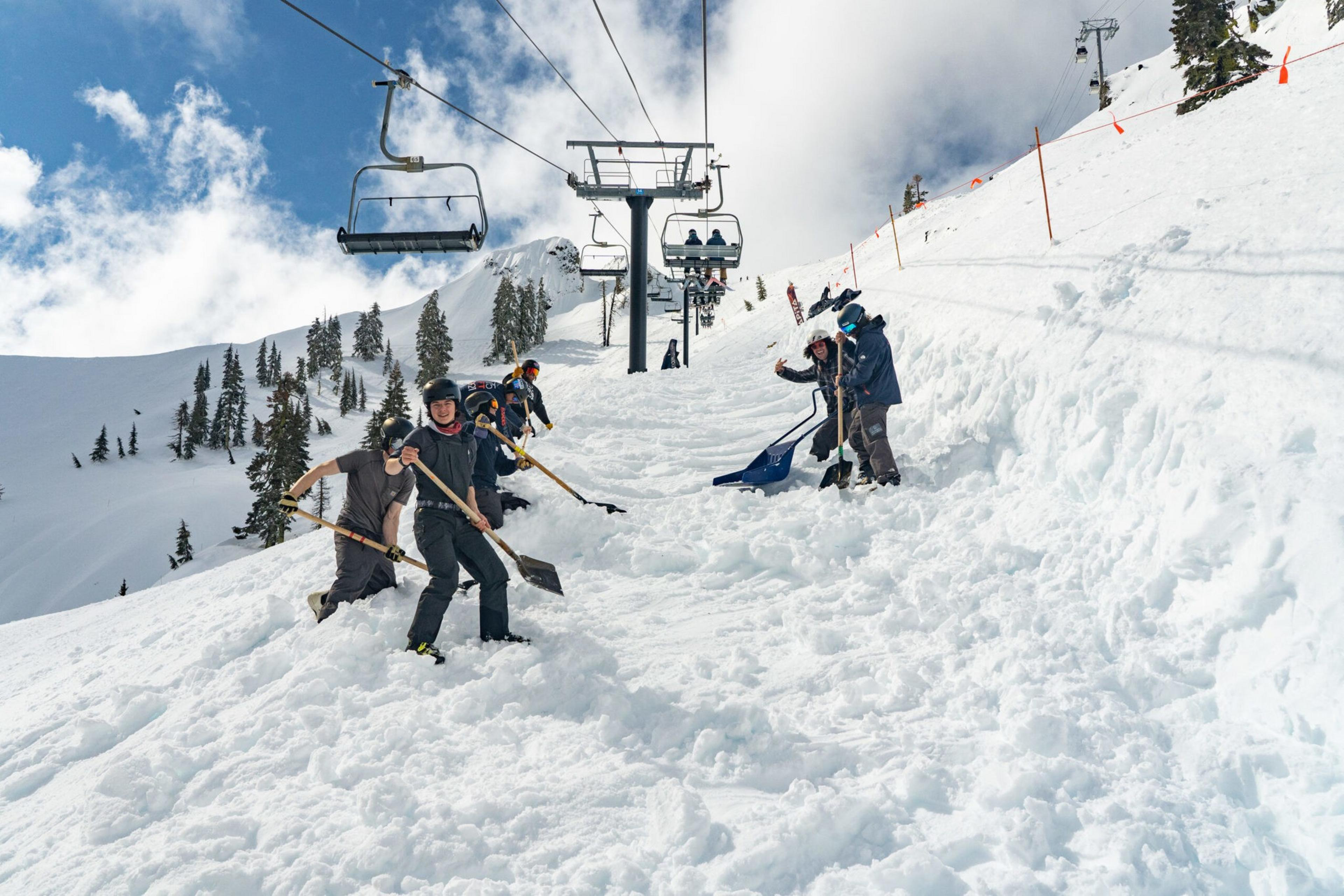 Workers dig through snow