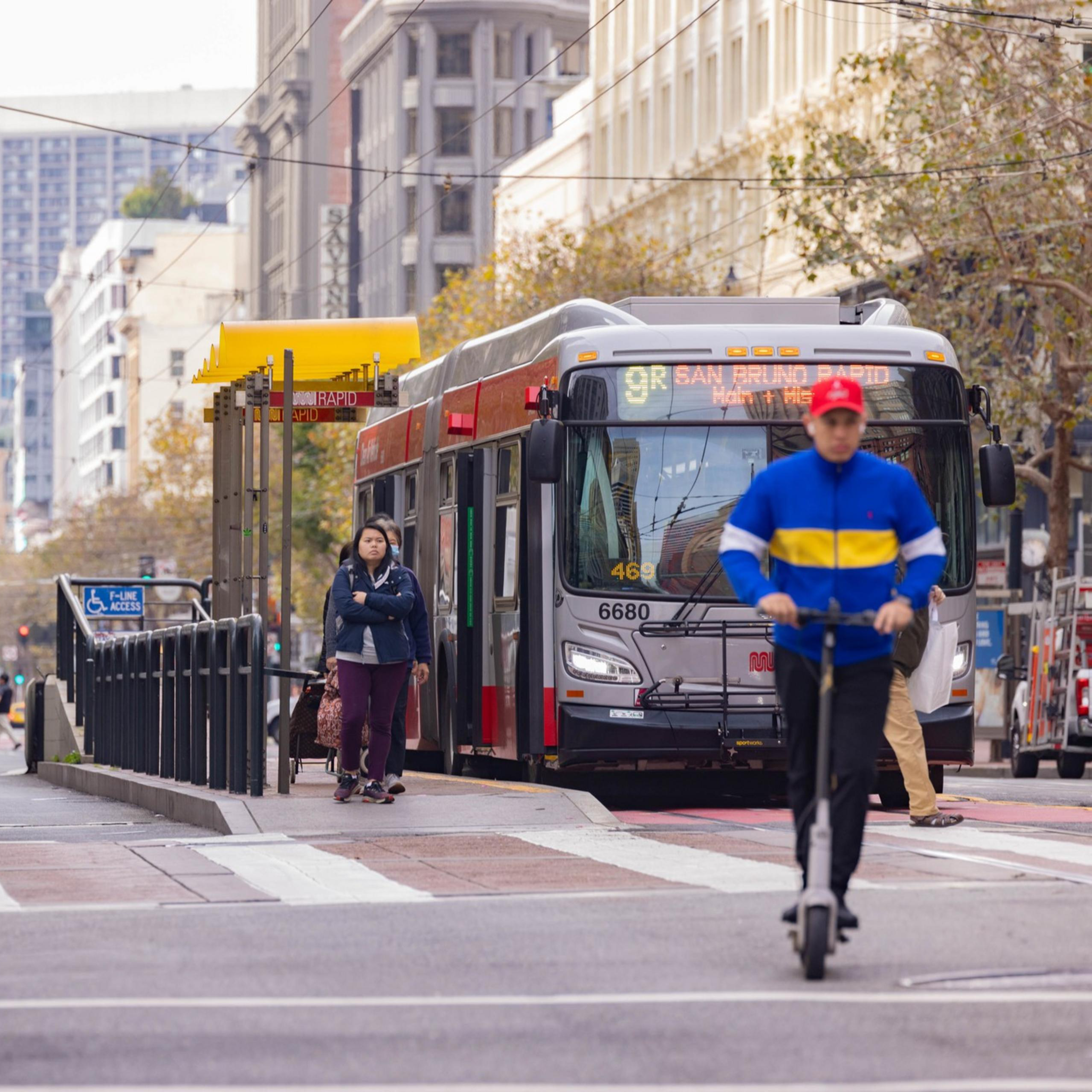 Bicyclists and scooter riders make their way down Market St.