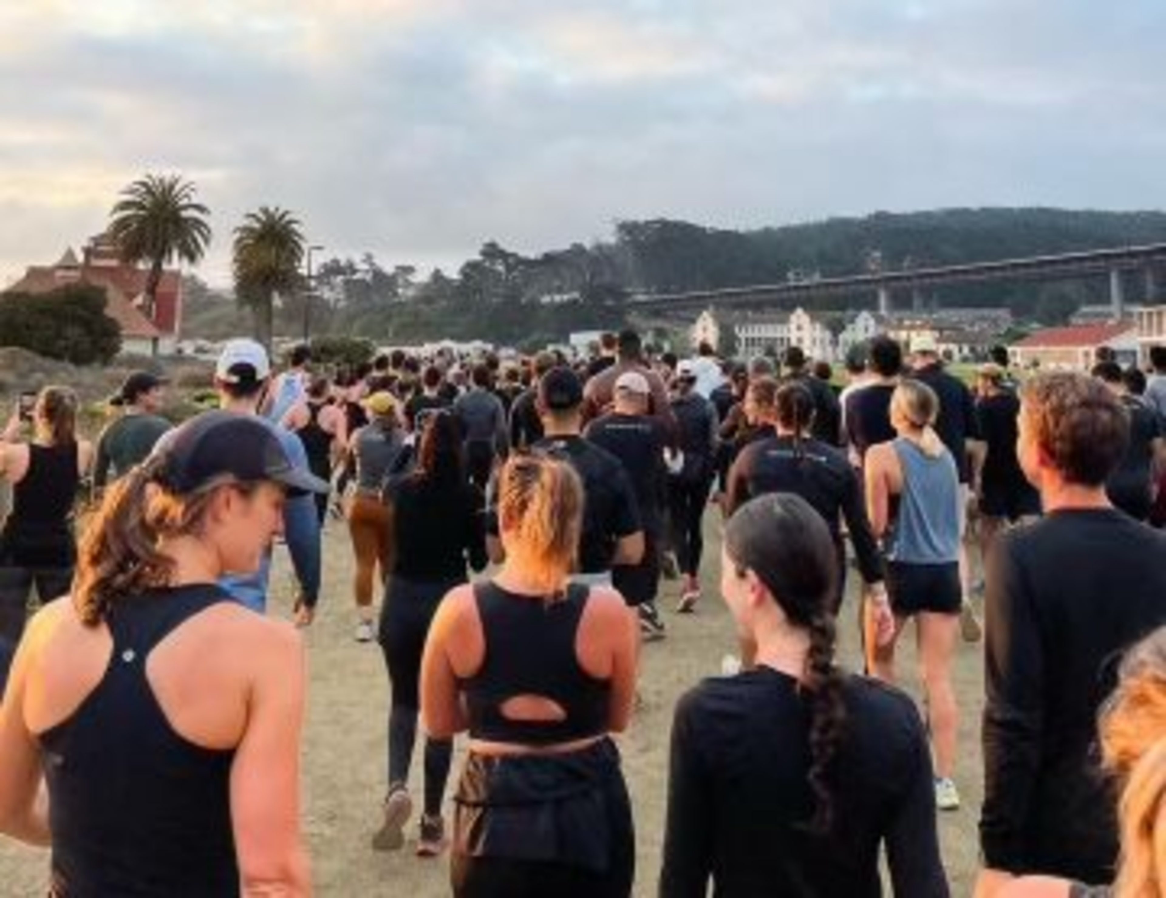 A large group of people dressed in athletic wear are running or walking ...