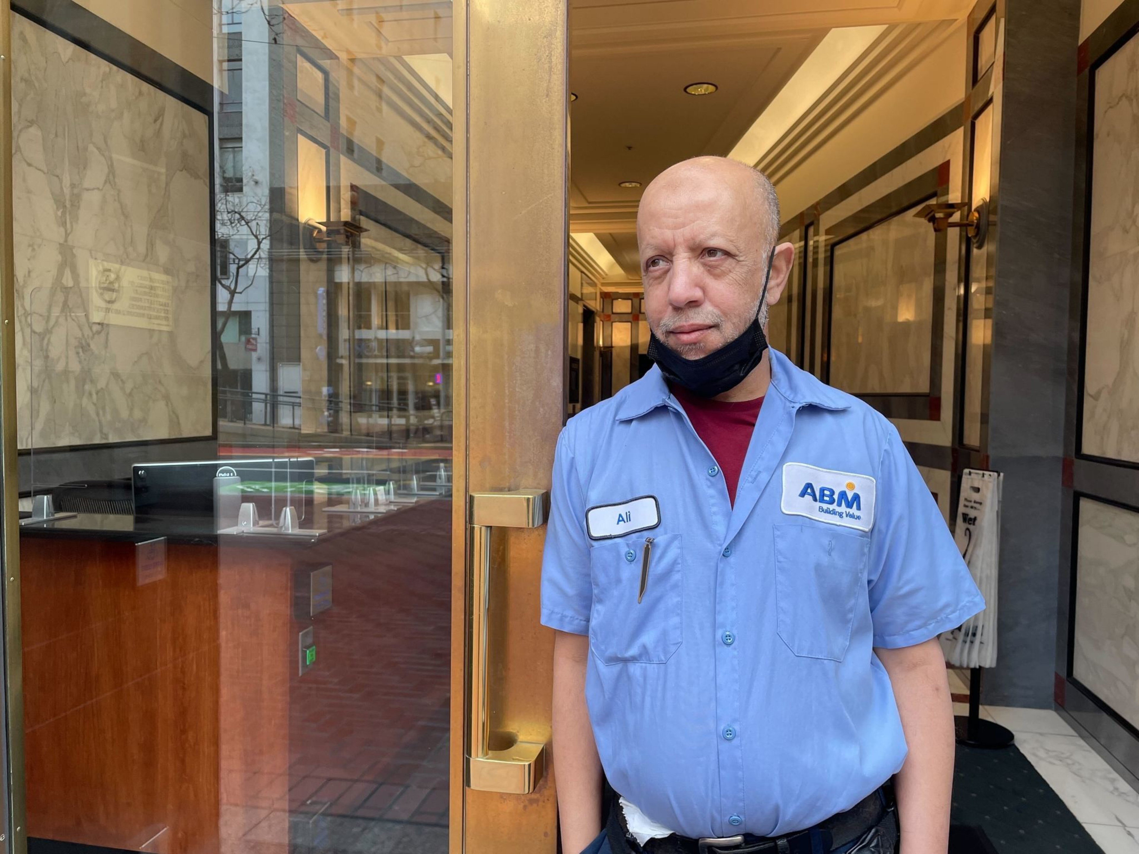 A man stands in the threshold of a building.