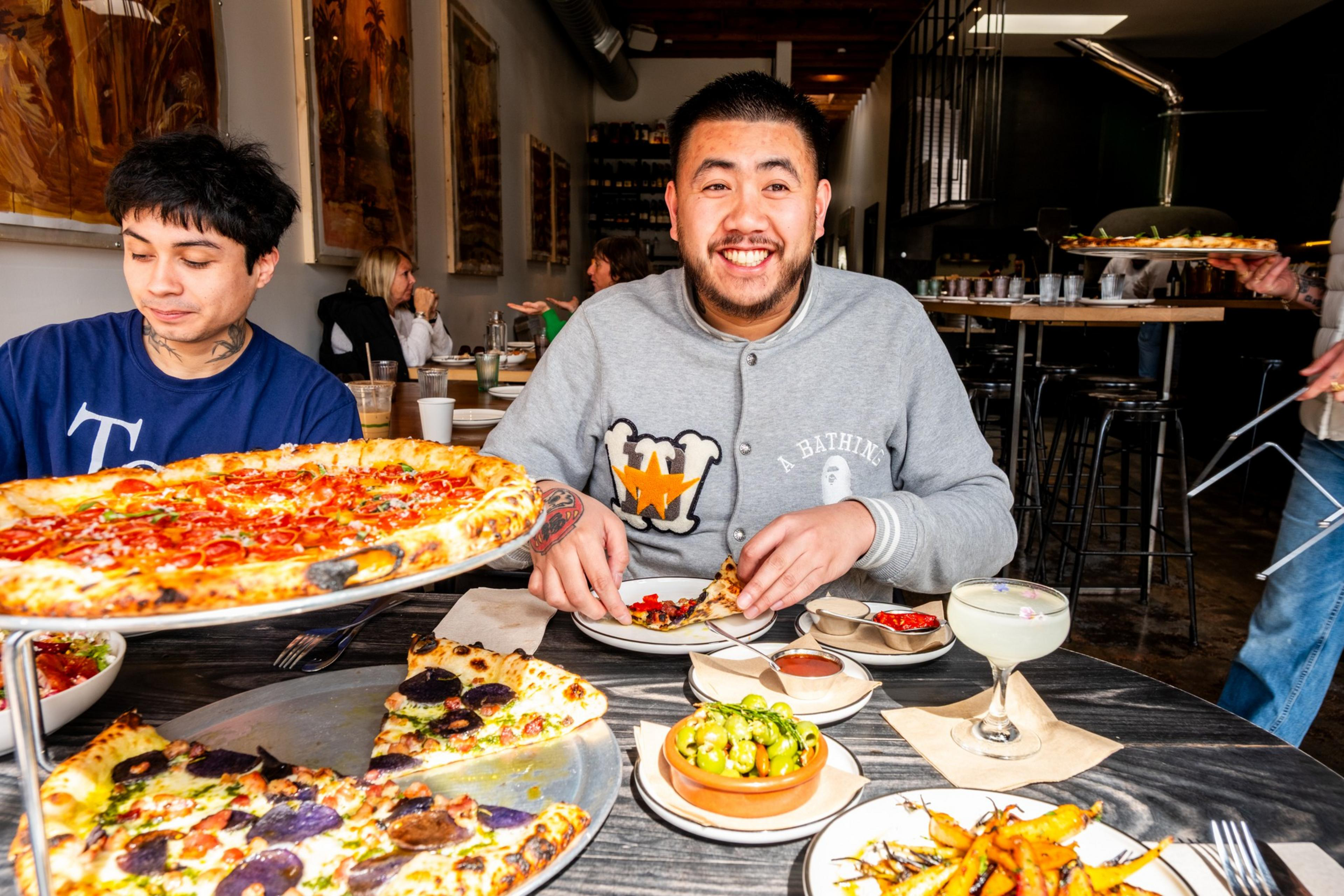 two people eating pizzas