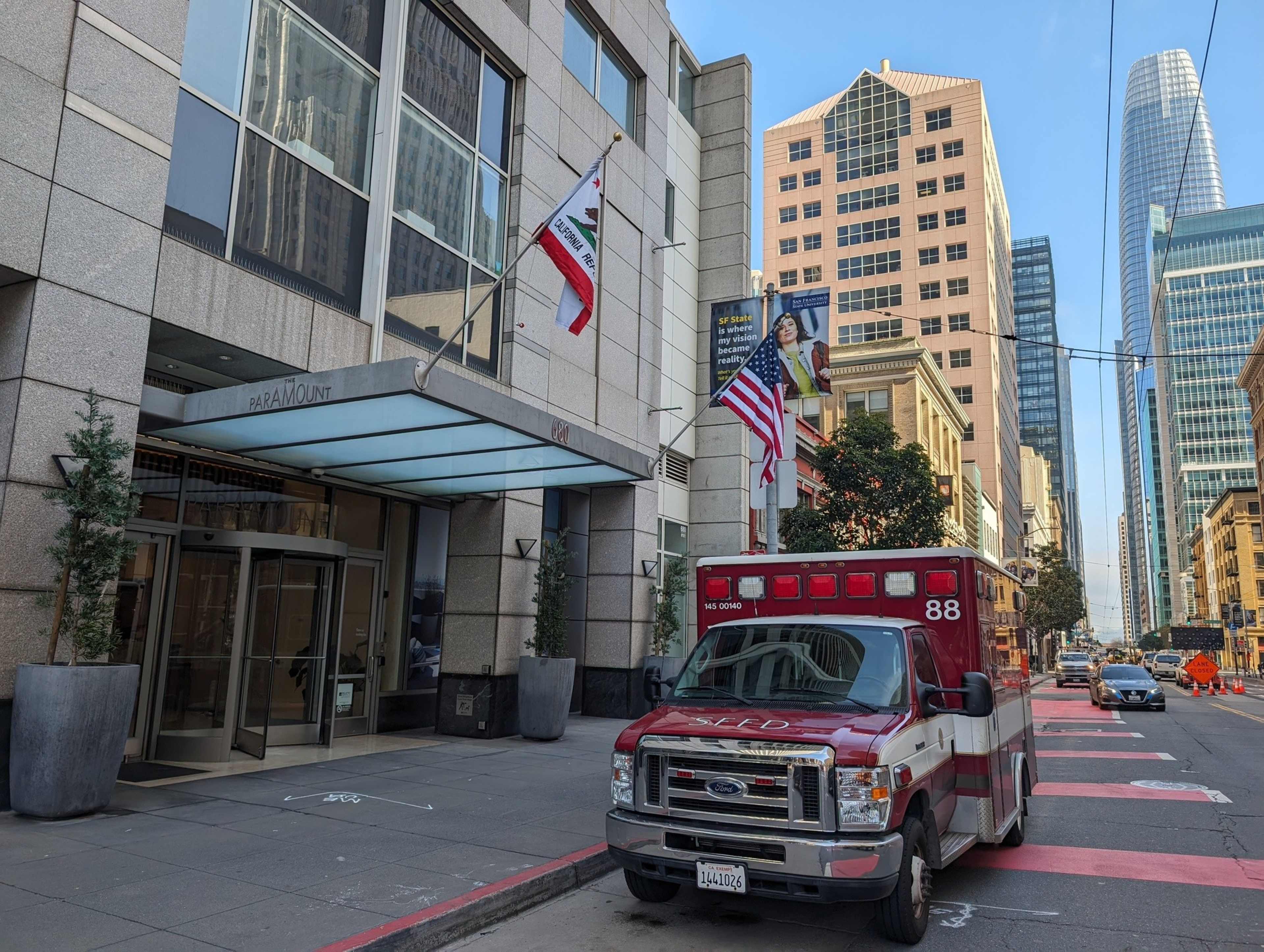 A paramedic van parks outside a downtown city building.