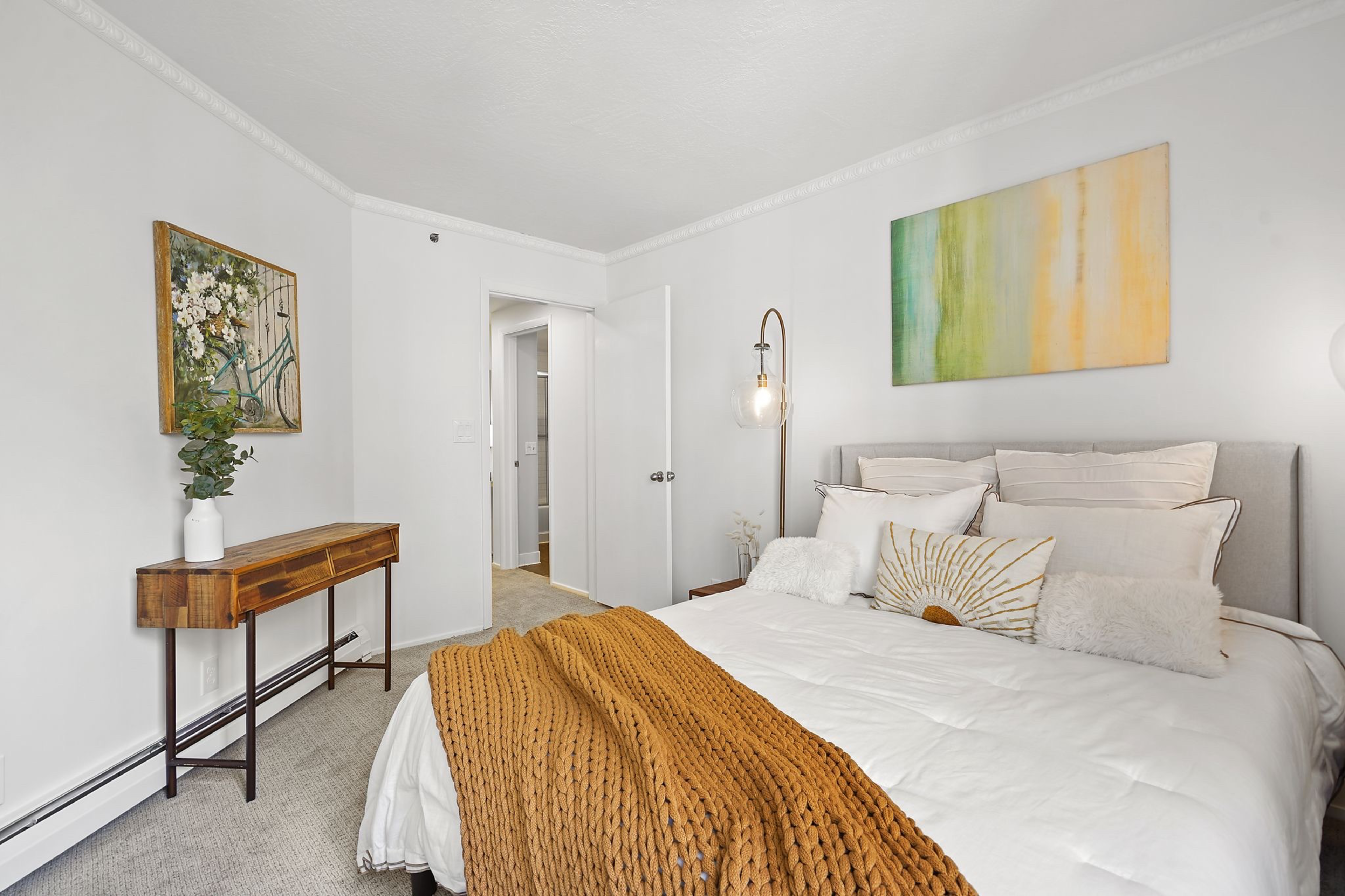 A large bed stands inside a bedroom.