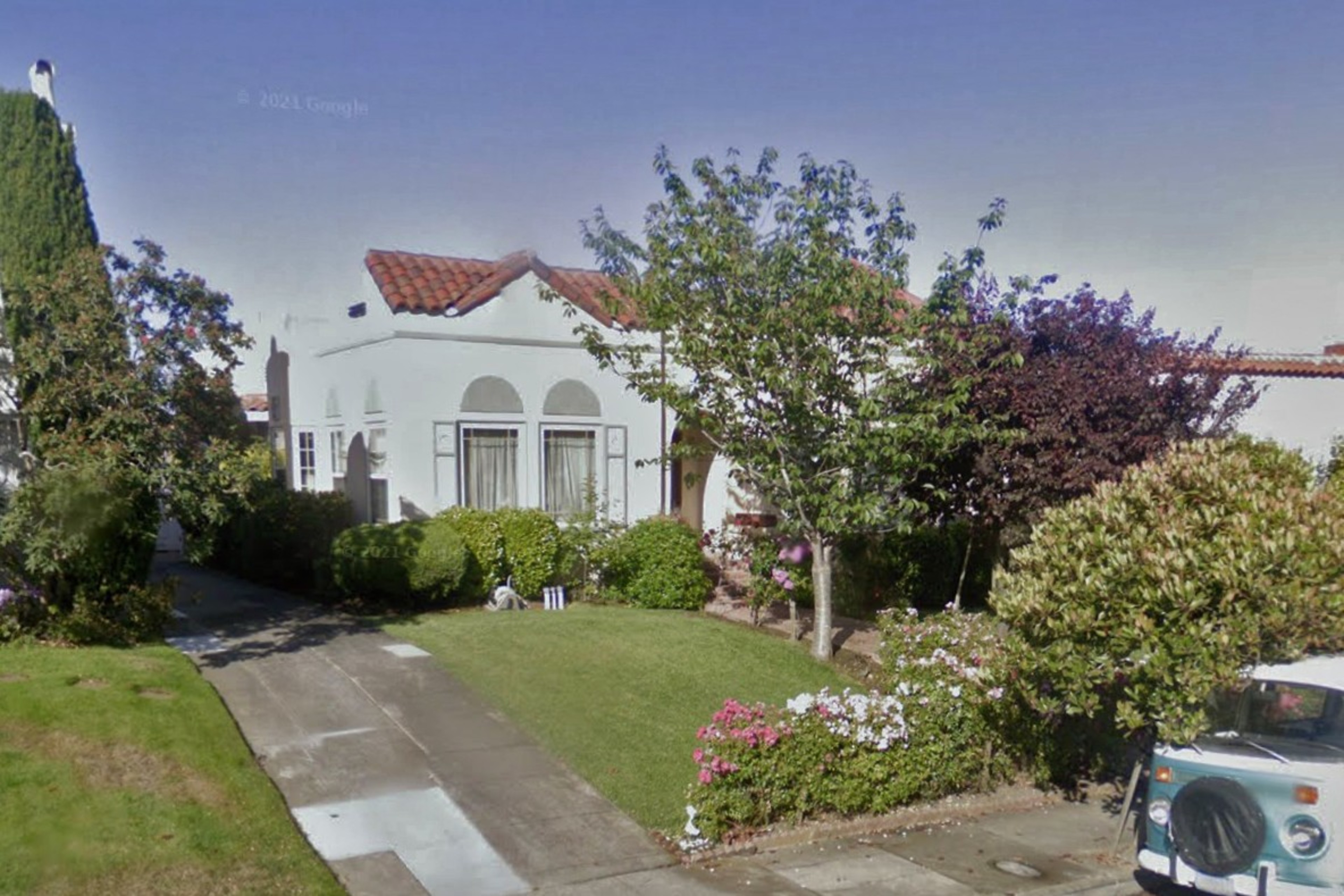 A white house with a tan top.