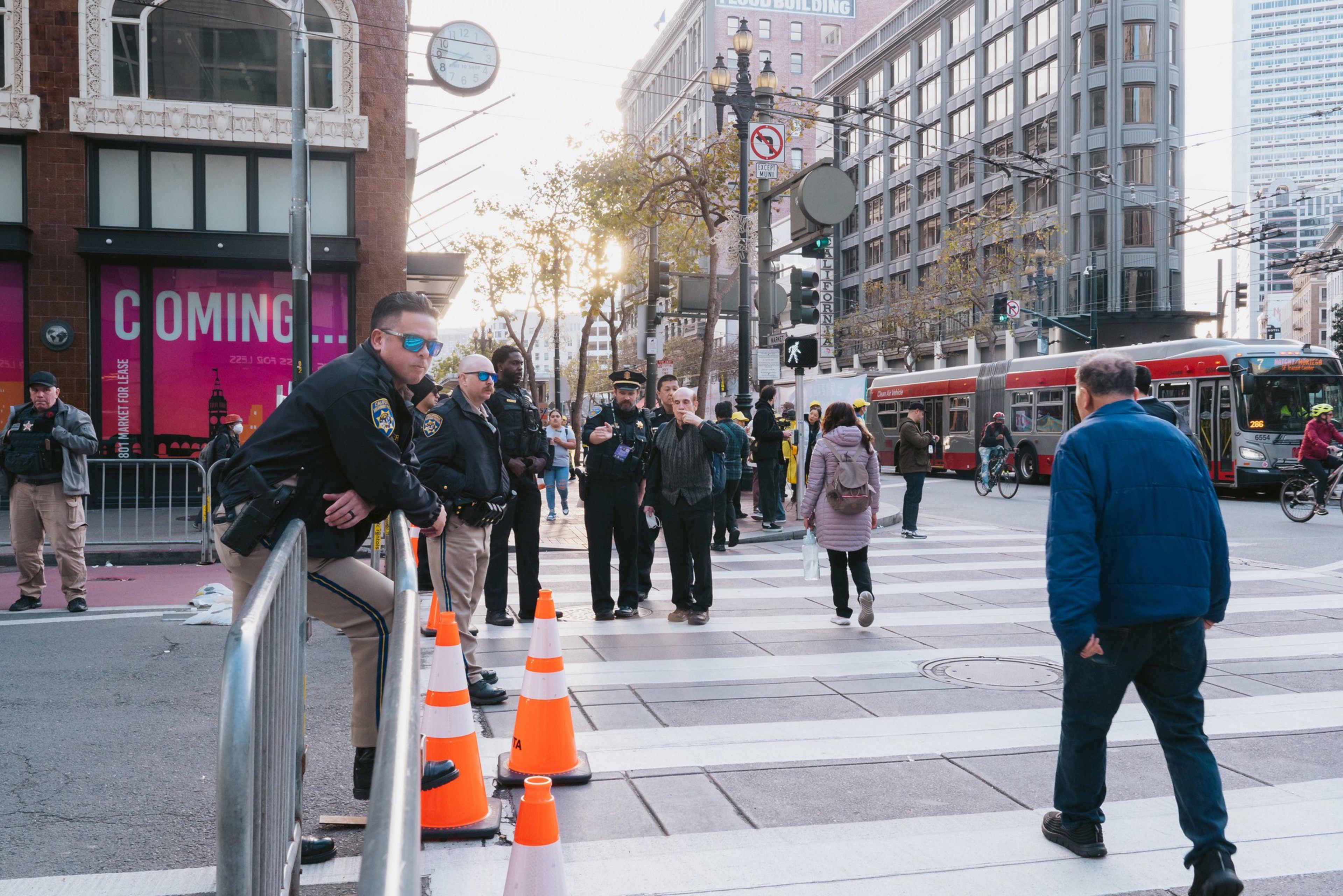 California Highway Parol officers stand behind barricades at a road closure on 4th at Market S