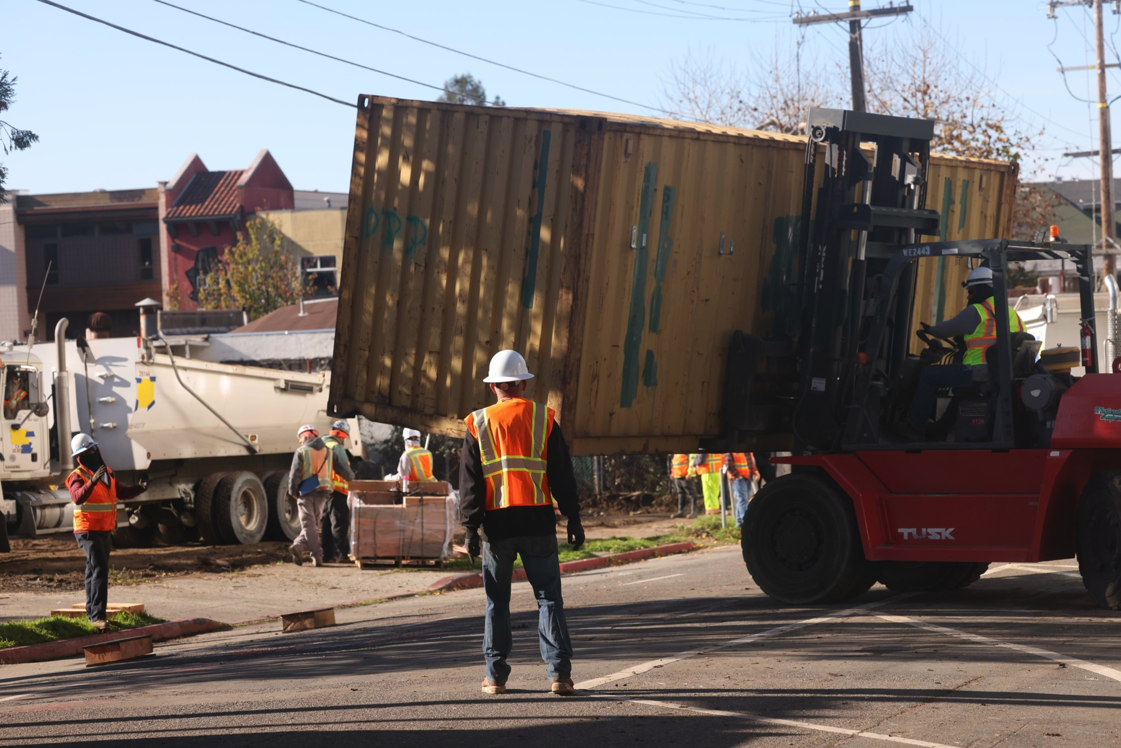 Workers move contains to block of Peoples Park. 