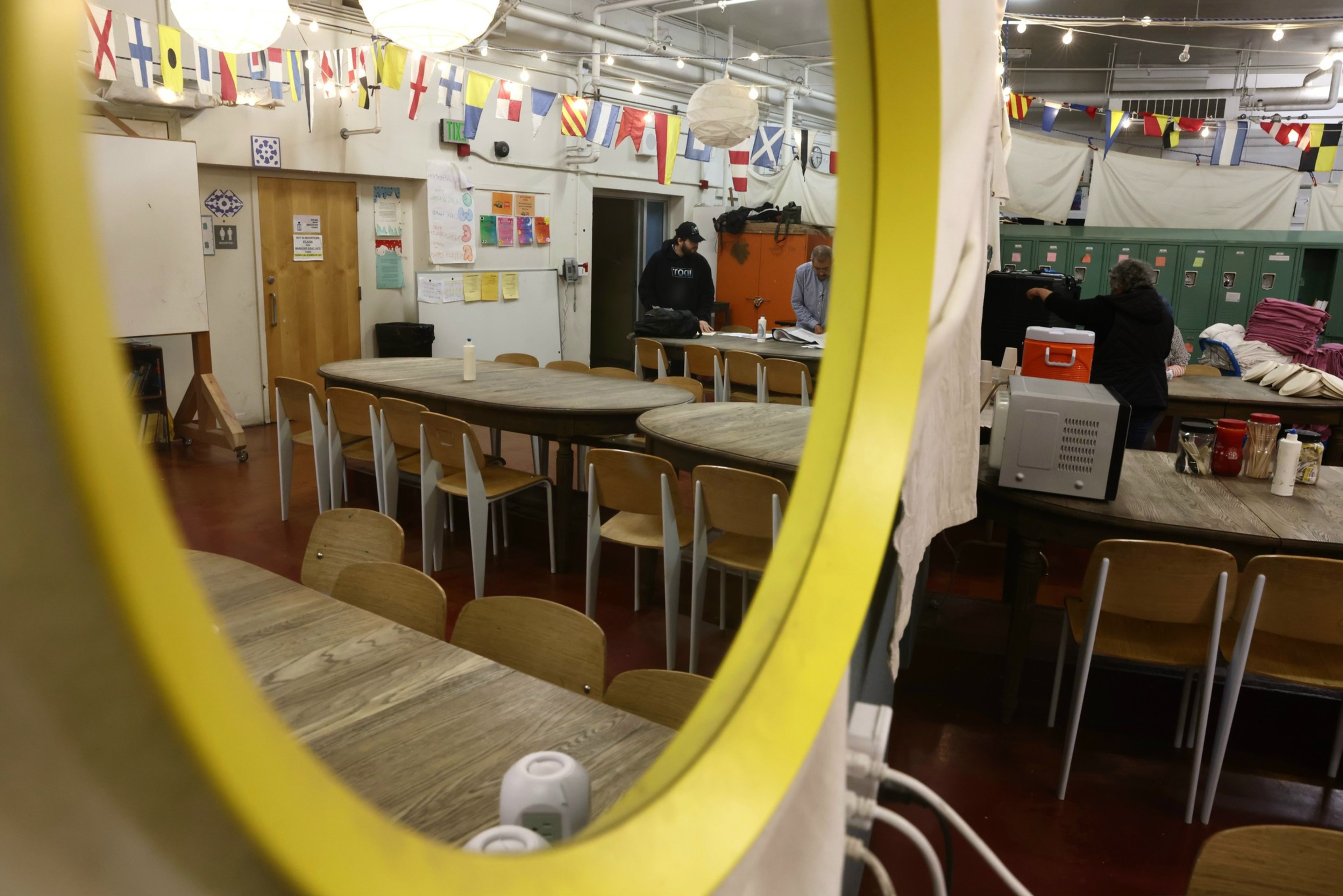 Volunteers and workers in the dining hall of a homeless shelter right before people start to arrive.