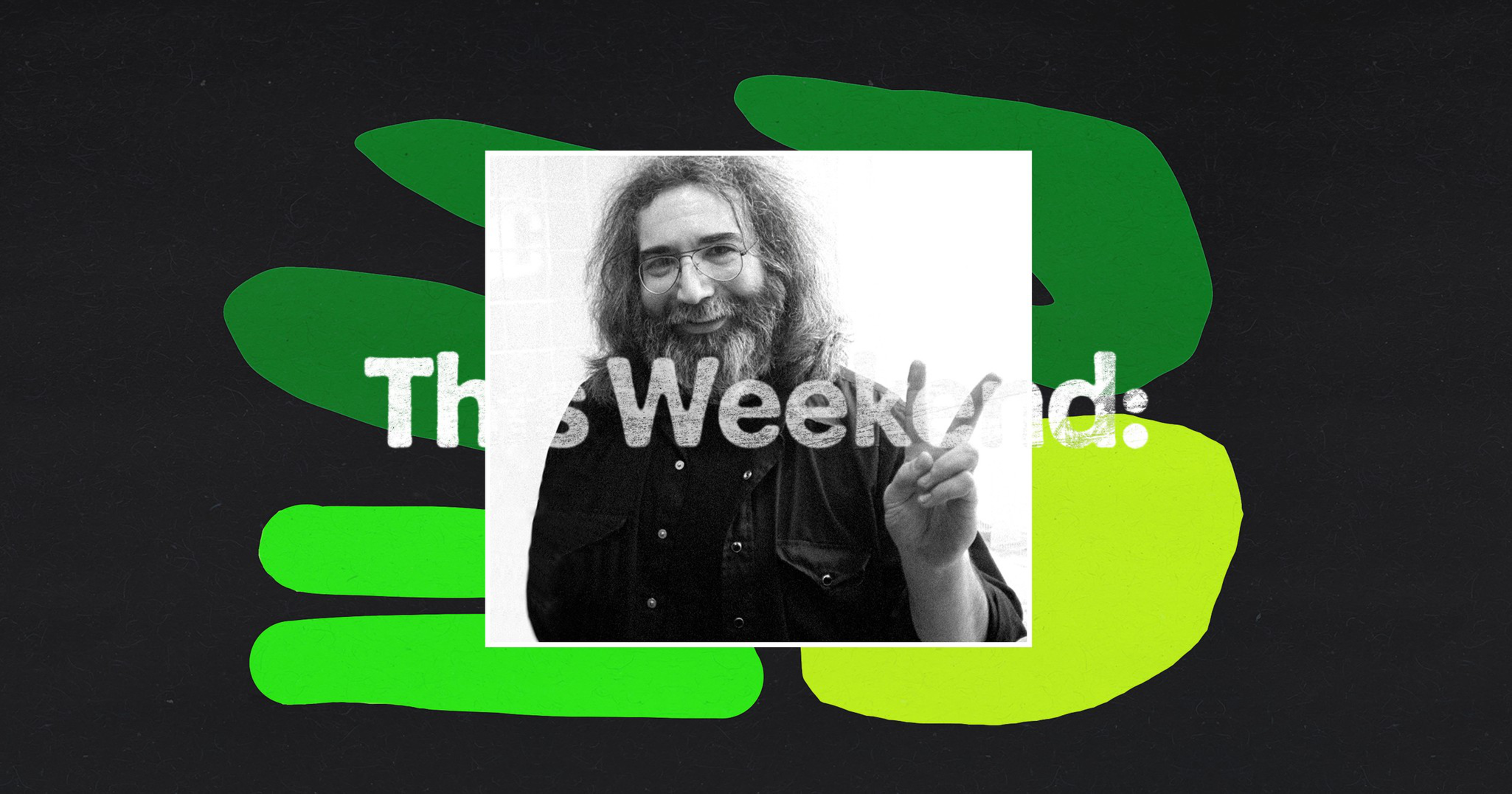 A black-and-white photo of a smiling man with long hair and beard, wearing glasses and making a peace sign with his right hand.