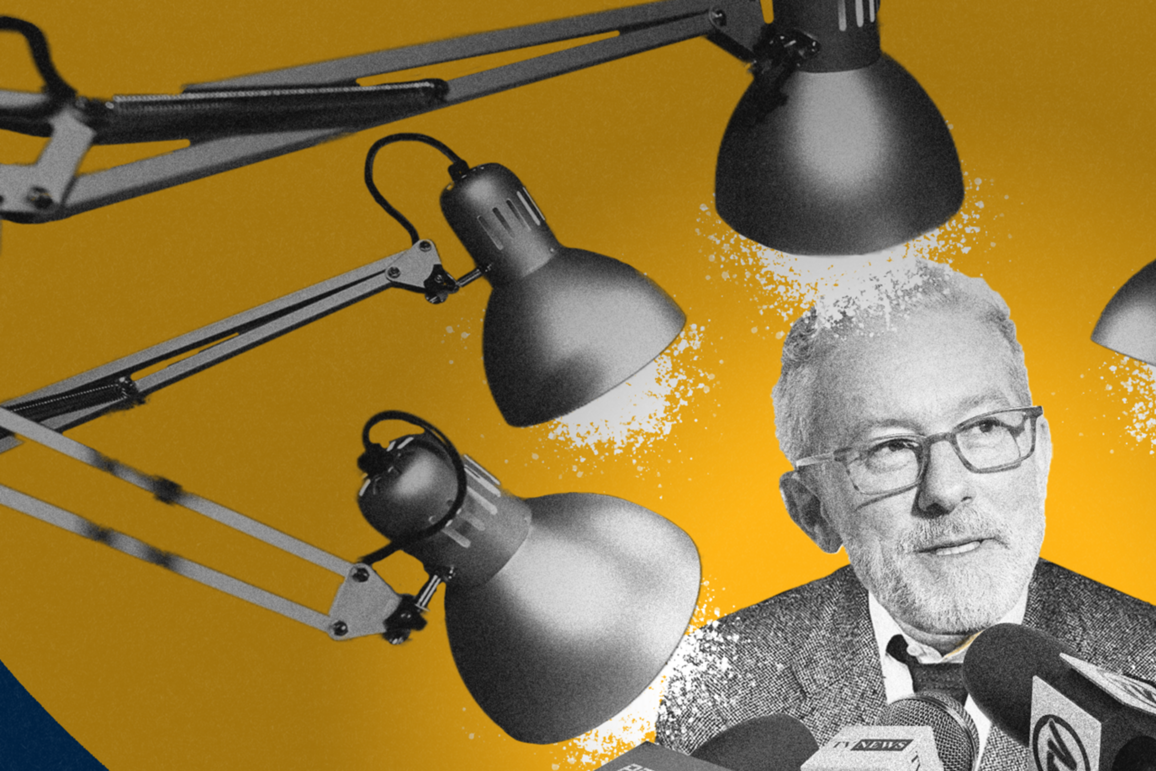 A man with glasses sits at a table surrounded by microphones, with multiple desk lamps aimed at him. The background is a blend of blue and yellow.