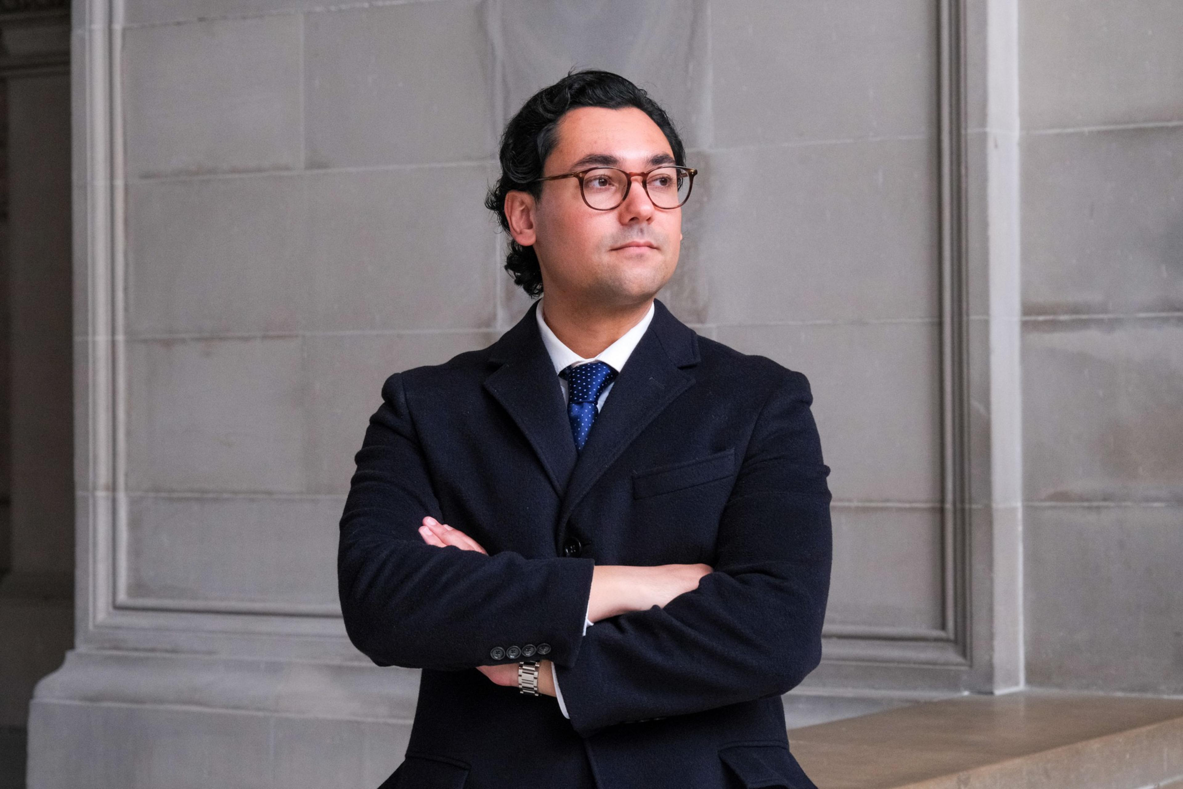 A man stands with arms crossed