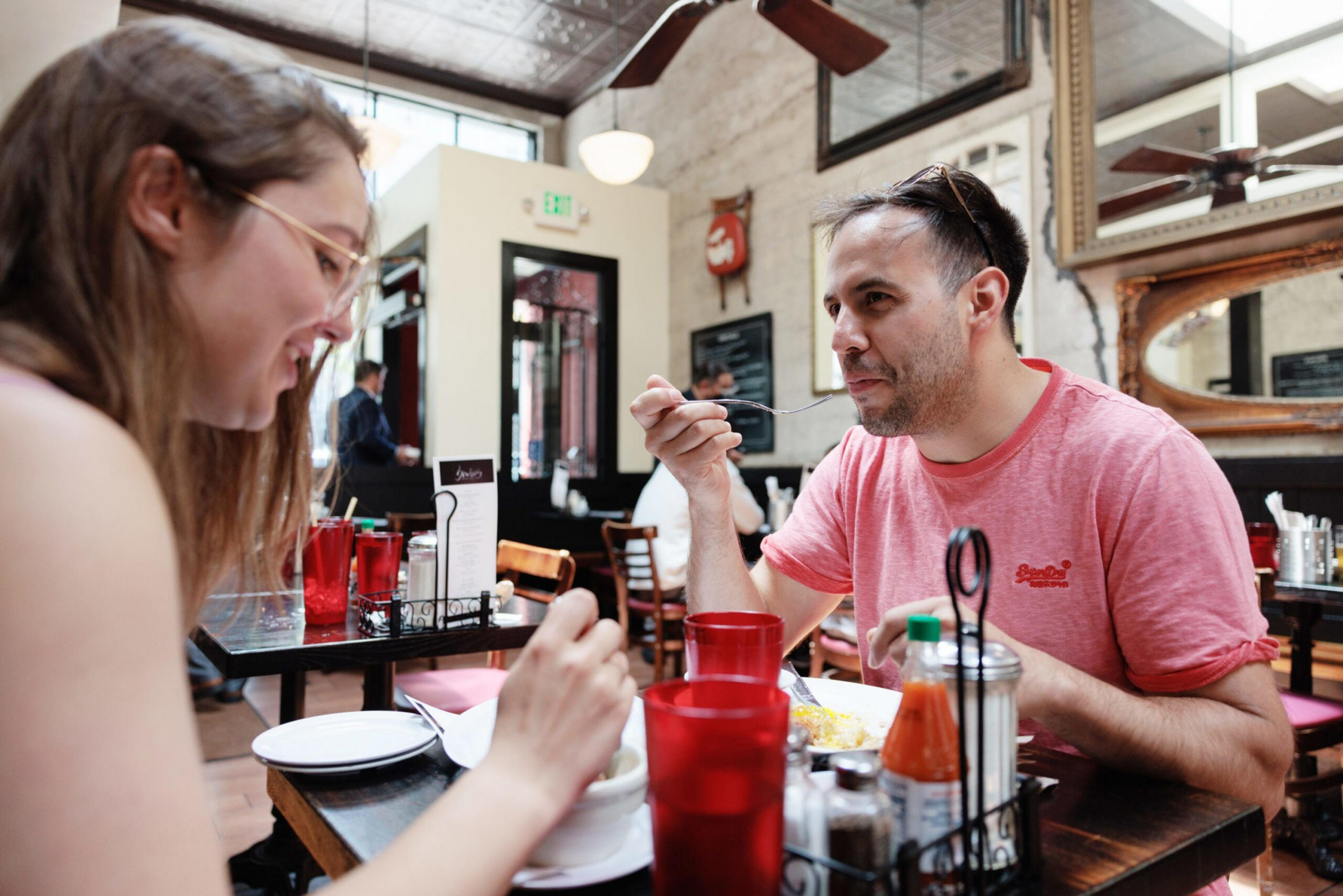 Two people eat at Brenda's French Soul Food.