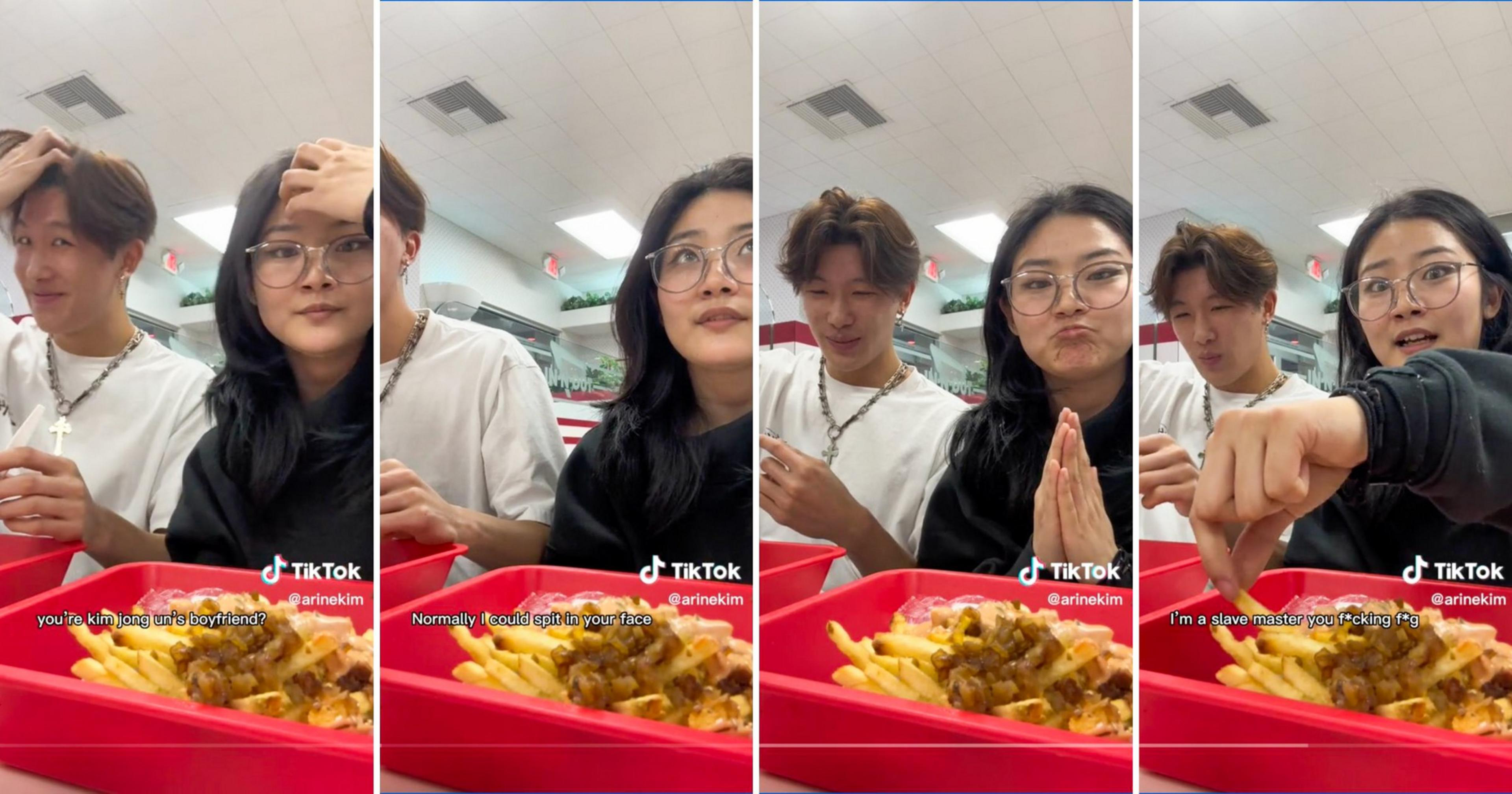 Two young people sit at a table with red trays of food, exchanging playful expressions and gestures in a casual, well-lit setting.