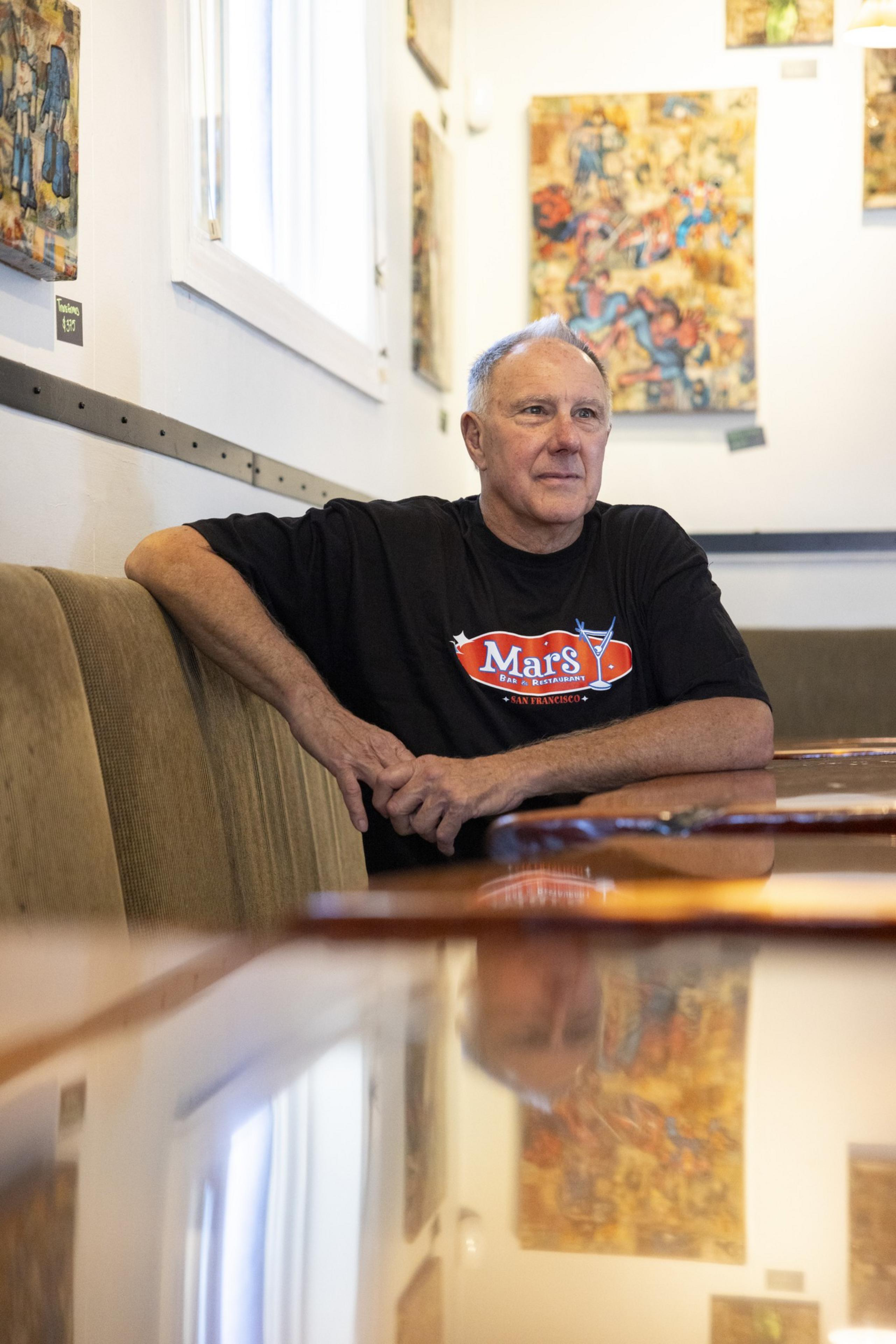 A man sits in a bar.