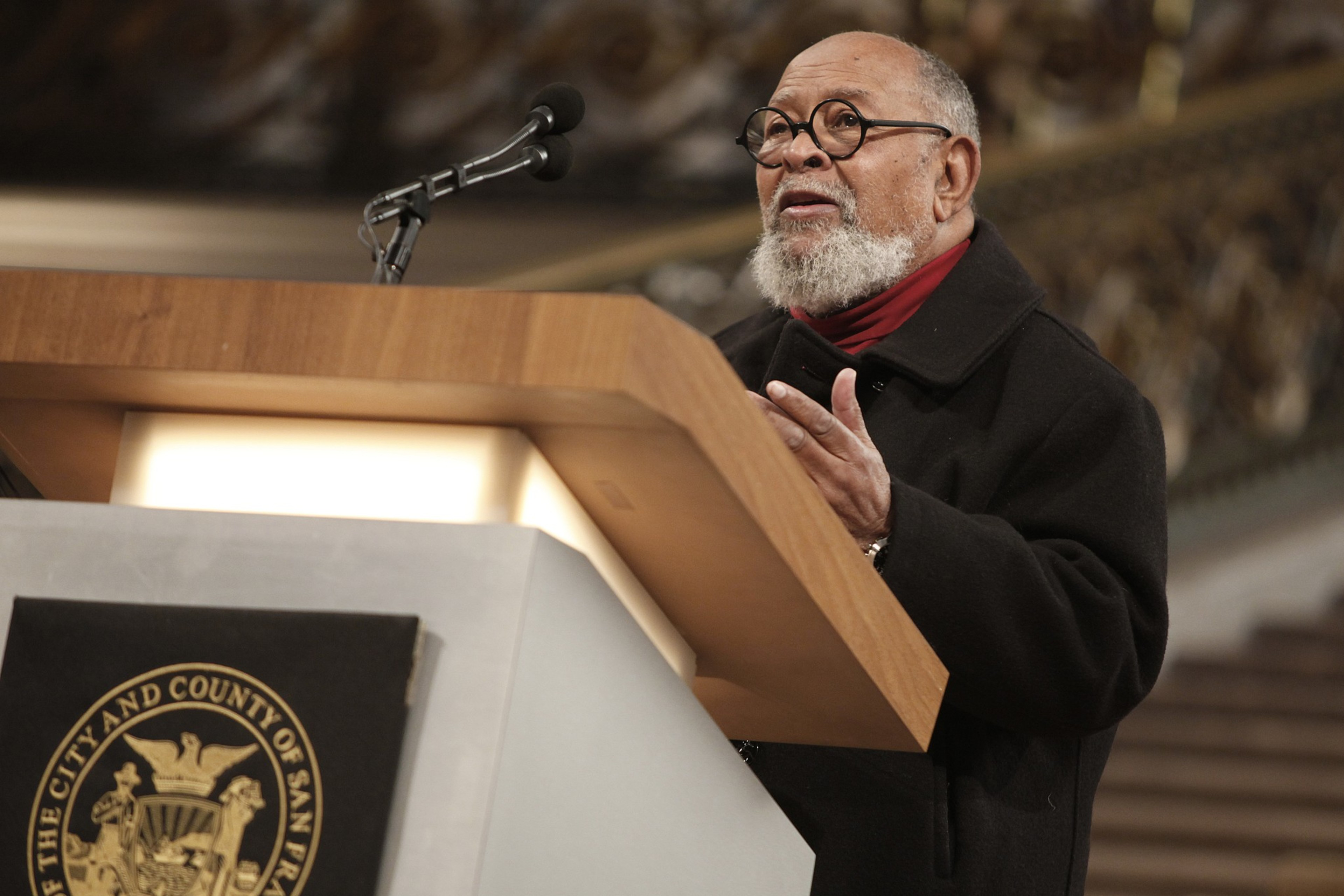 A man speaks at a podium.