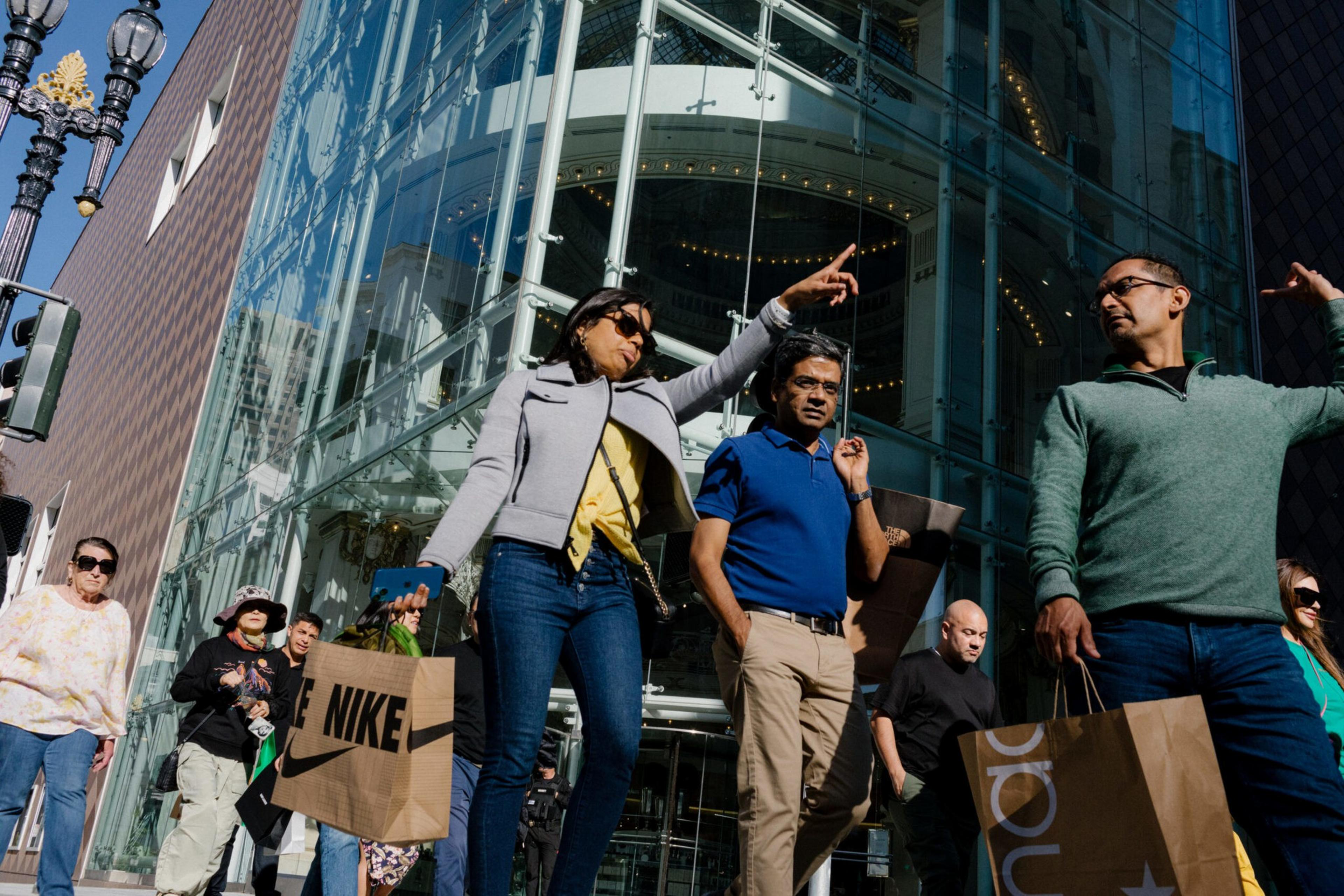 Shoppers in Union Square cross the street.