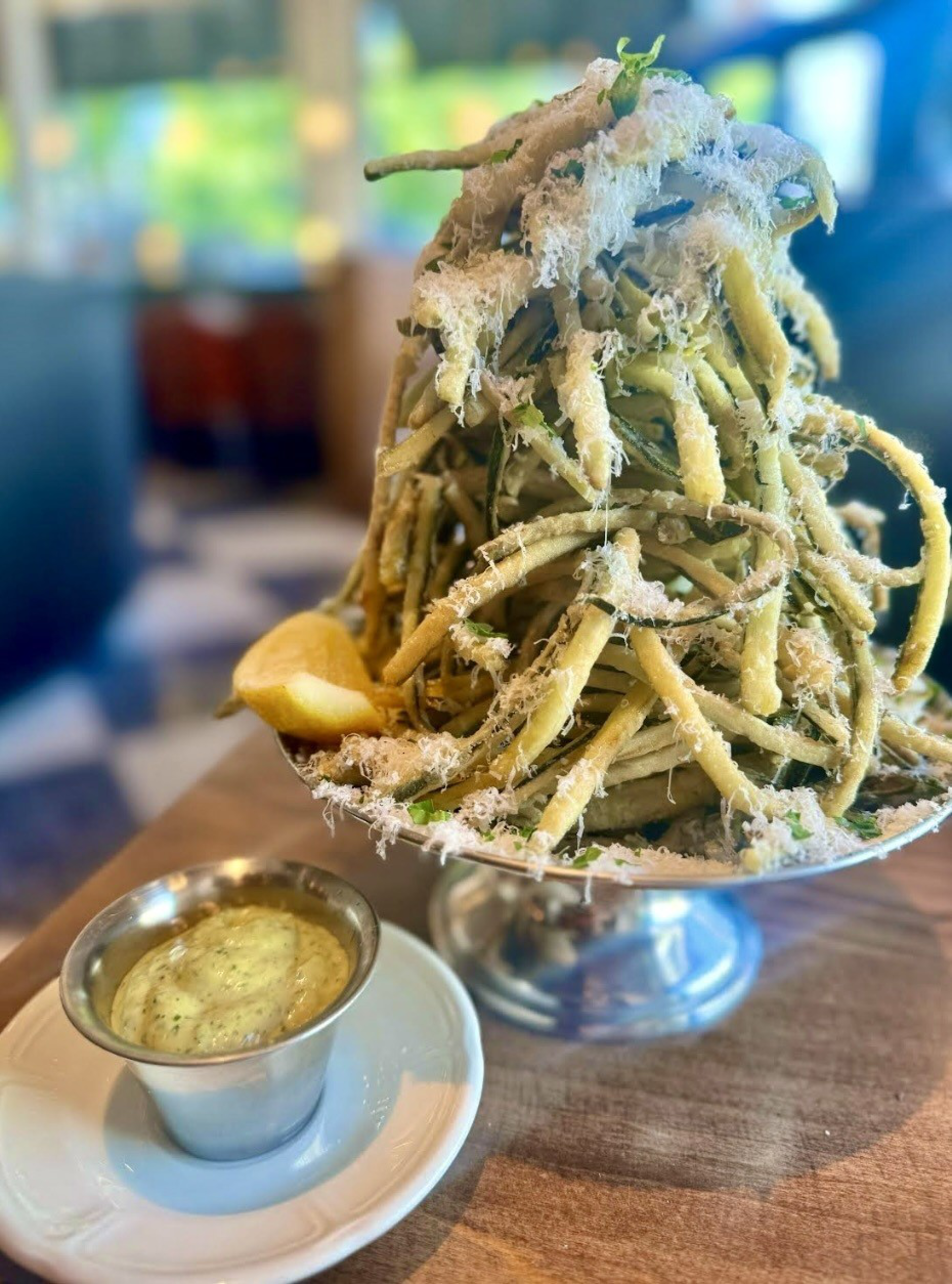 A tall pile of fried zucchini.