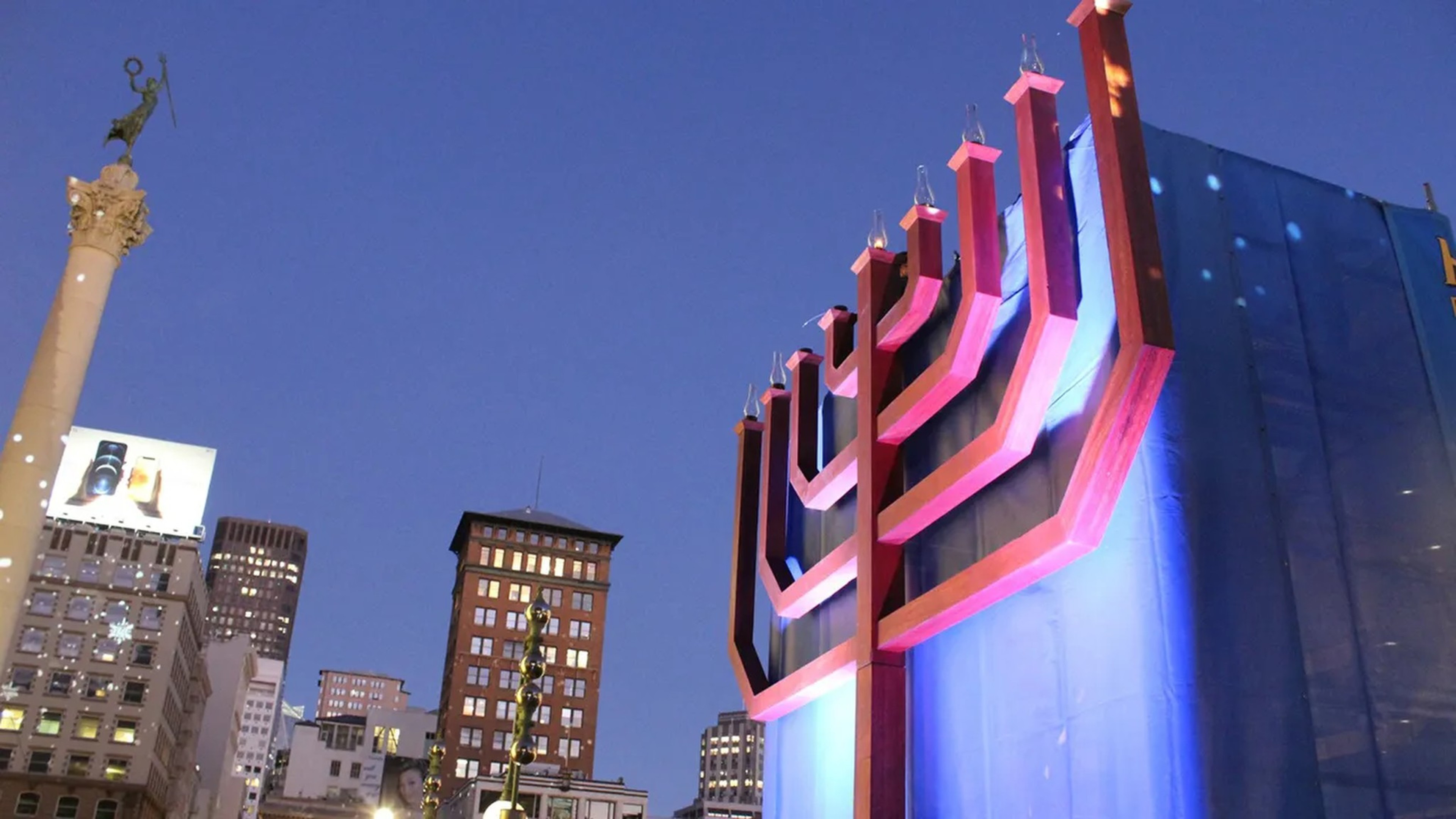 A red menorah on a building.