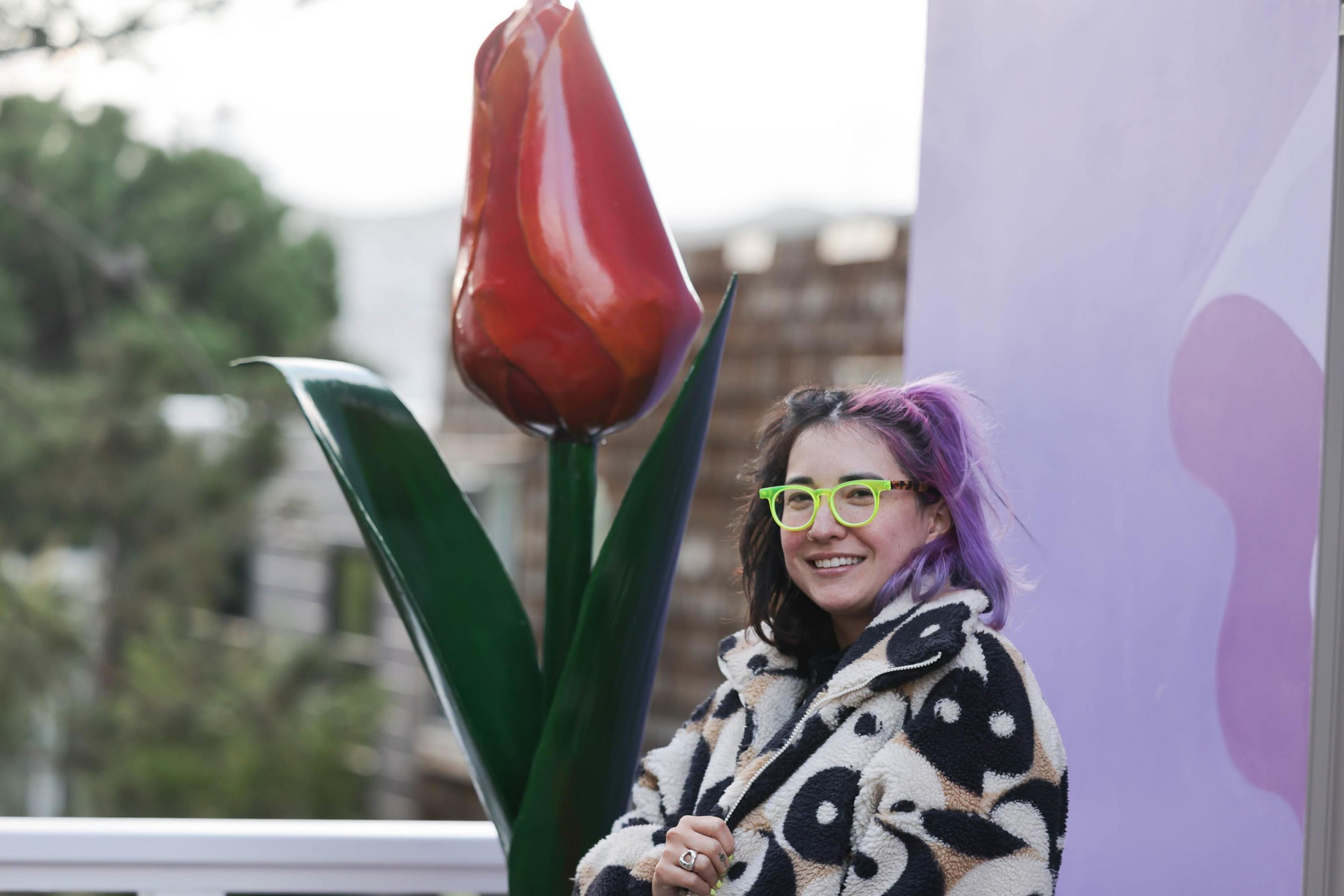Tay &quot;BeepBoop&quot; Nakamoto stands in front of a seven-foot tall custom tulip sculpture for San Francisco's Floral House. 