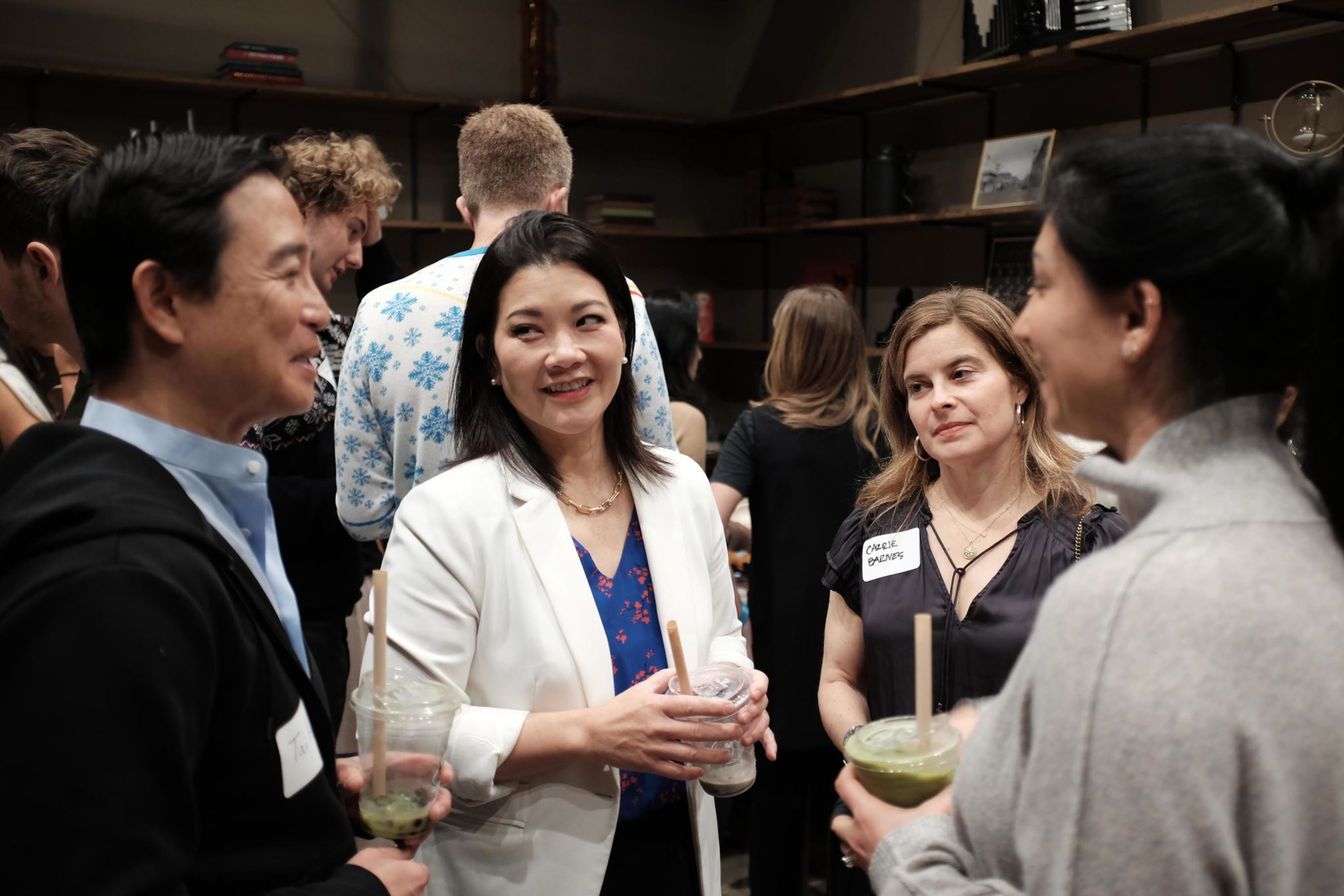 A group of moderate Democrats including prosecutor Nancy Tung gather in an office sipping Boba drinks. 