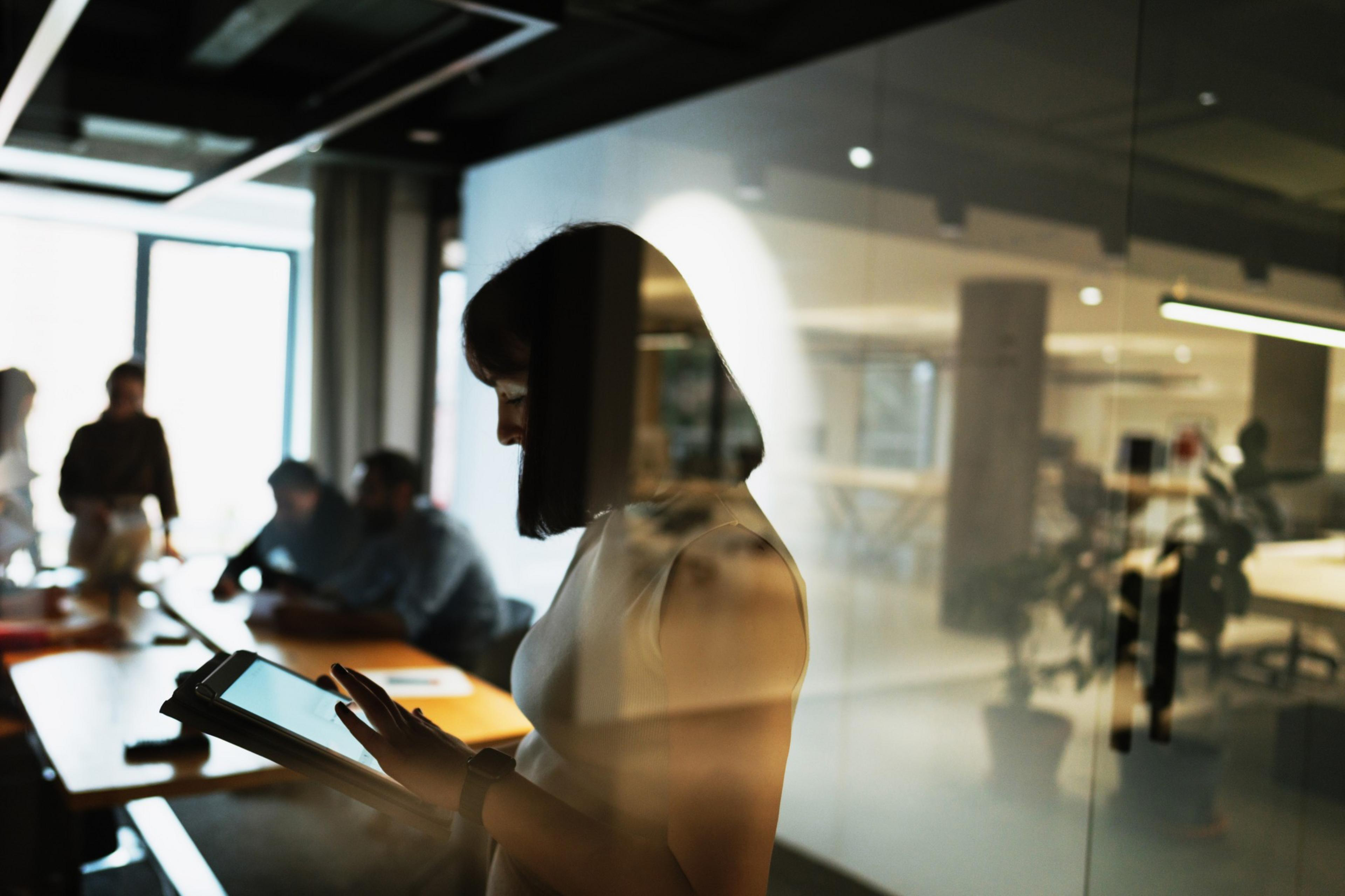 a silhouette of a woman in an office