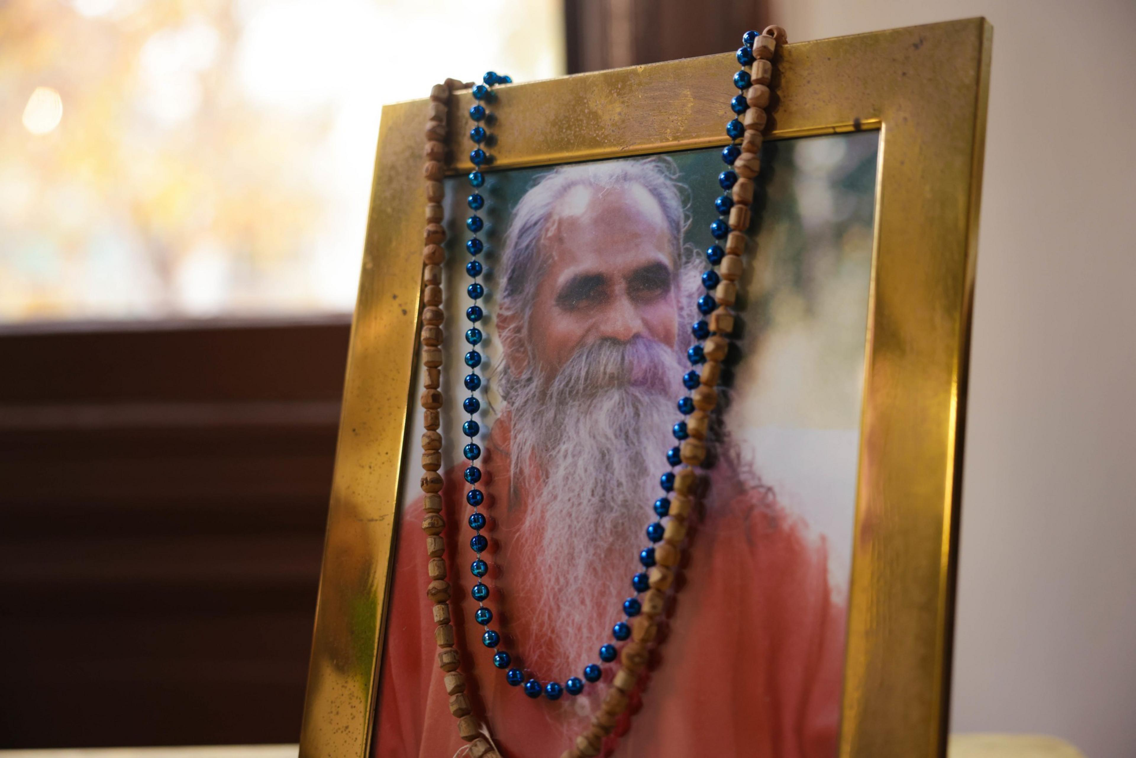 A detail of photo of Shri Brahmananda Sarasvati with beads hanging off the top