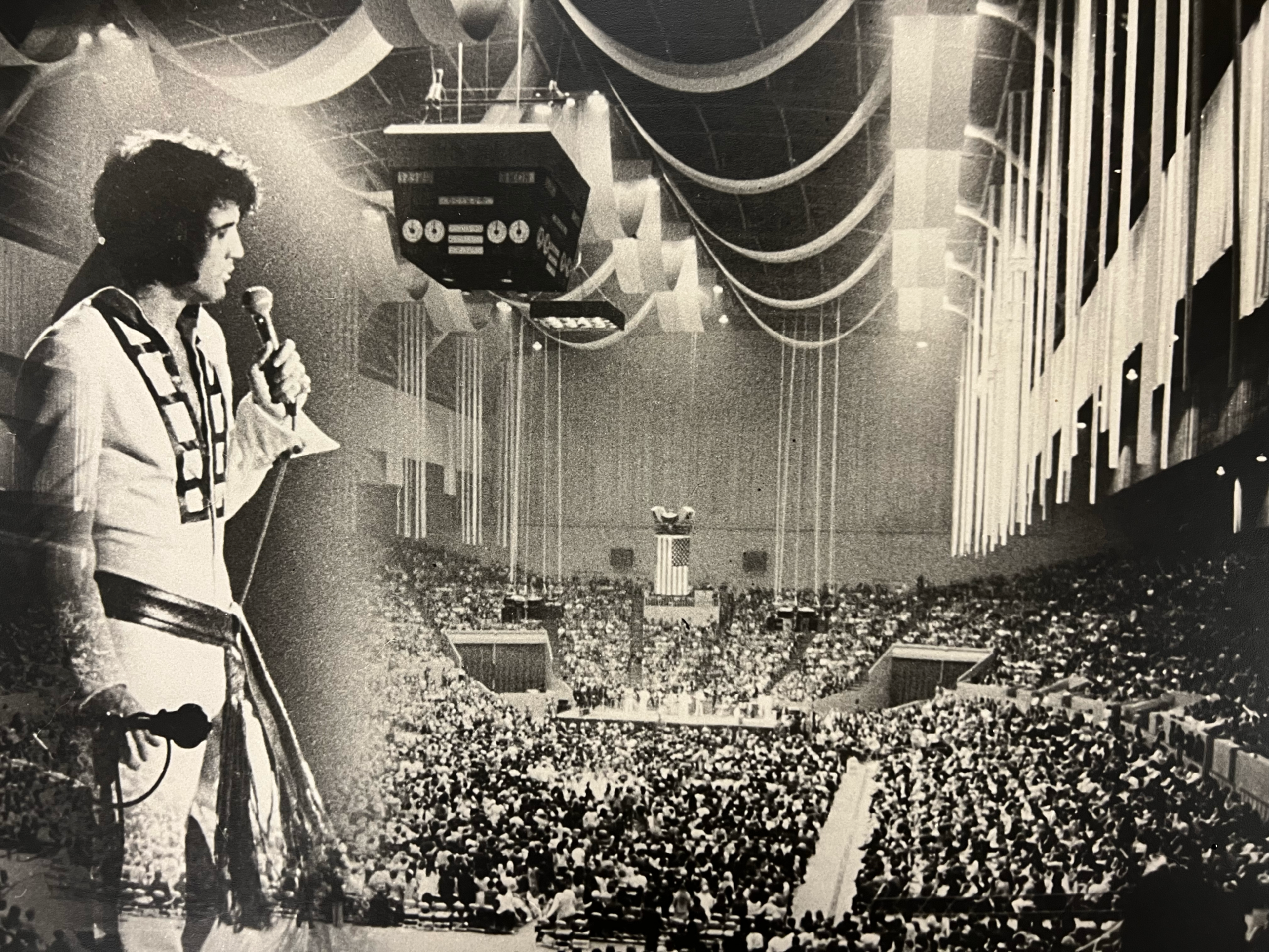 A photo illustration juxtaposes Elvis Presley wearing an iconic outfit and holding a microphone with the crowd at an arena.