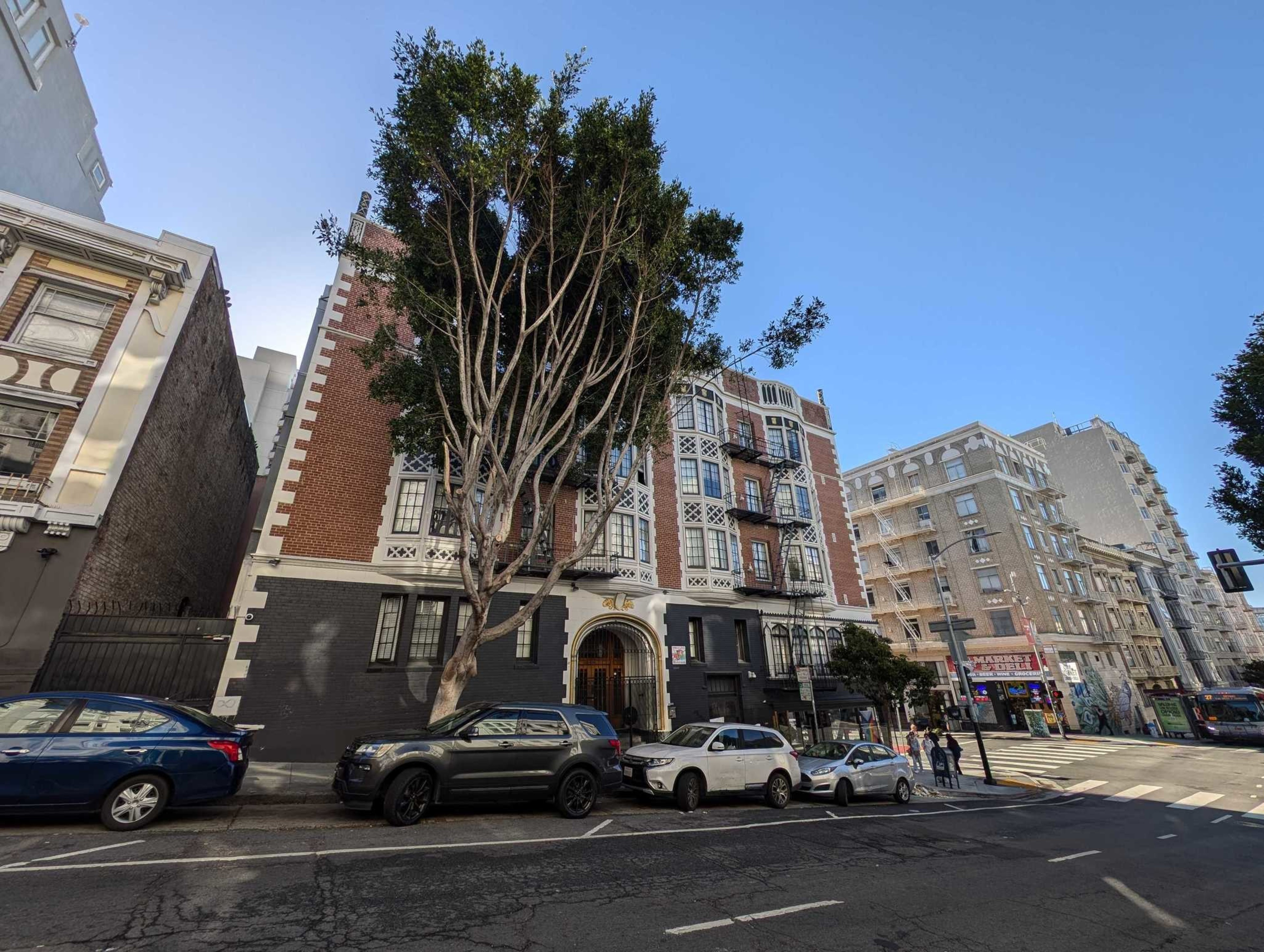 A 4-story apartment building is seen on a sunny day in San Francisco.