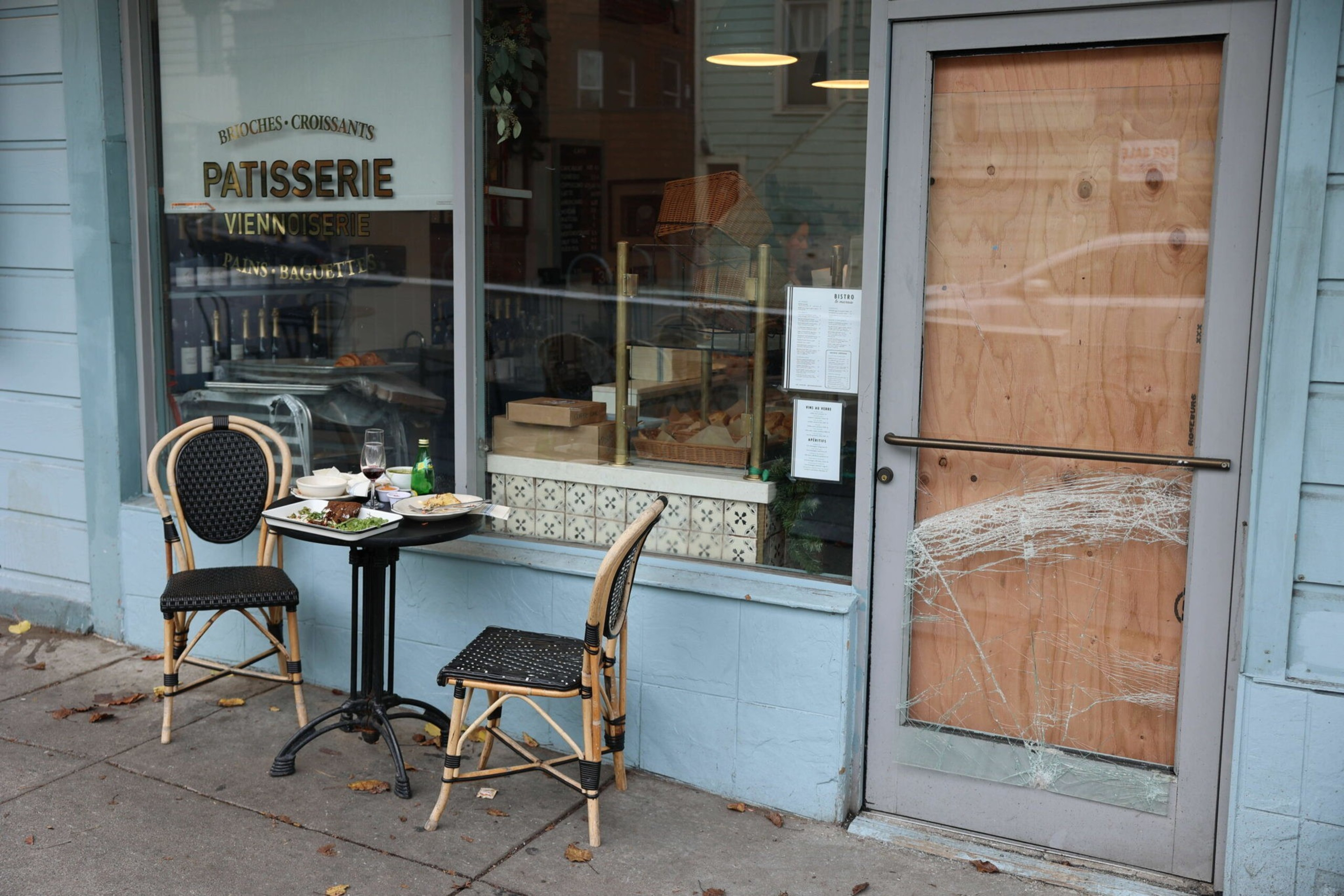 A smashed, boarded-up window outside Le Marais in the Castro.