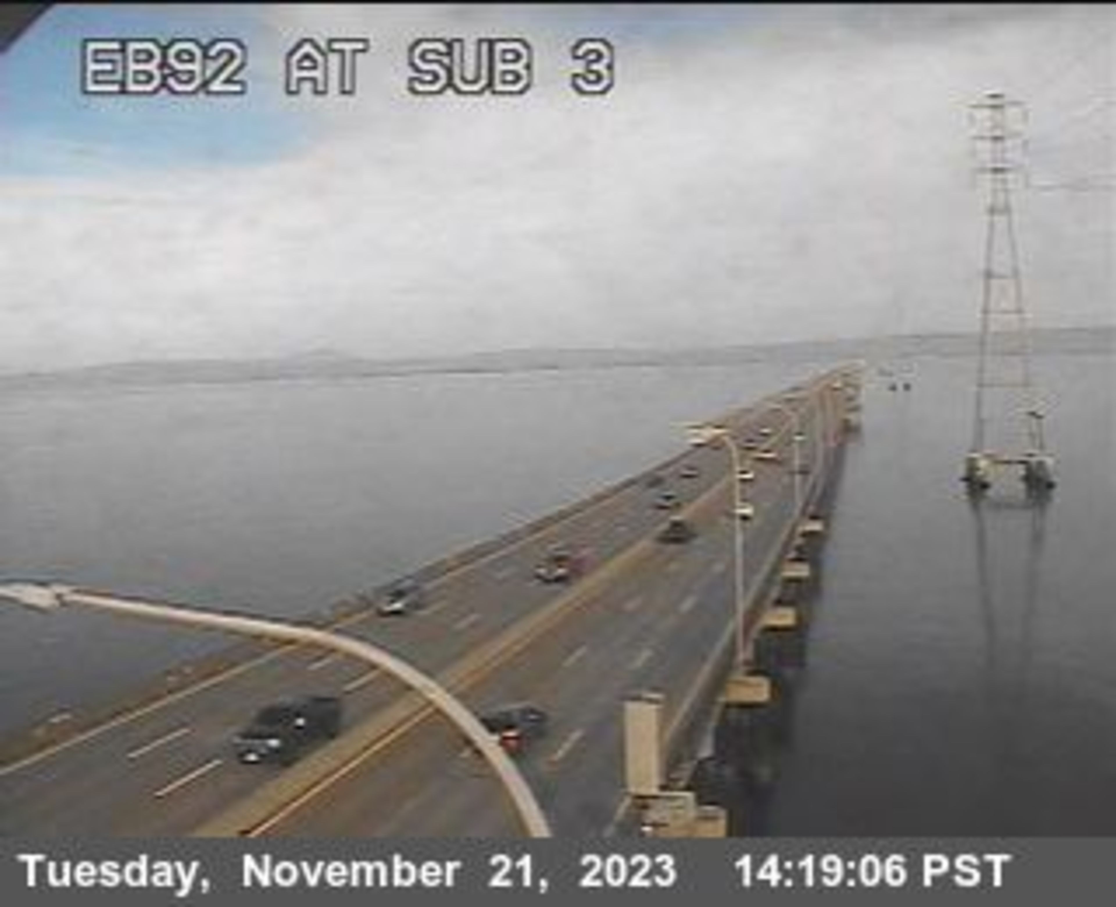 Cars drive on a bridge.