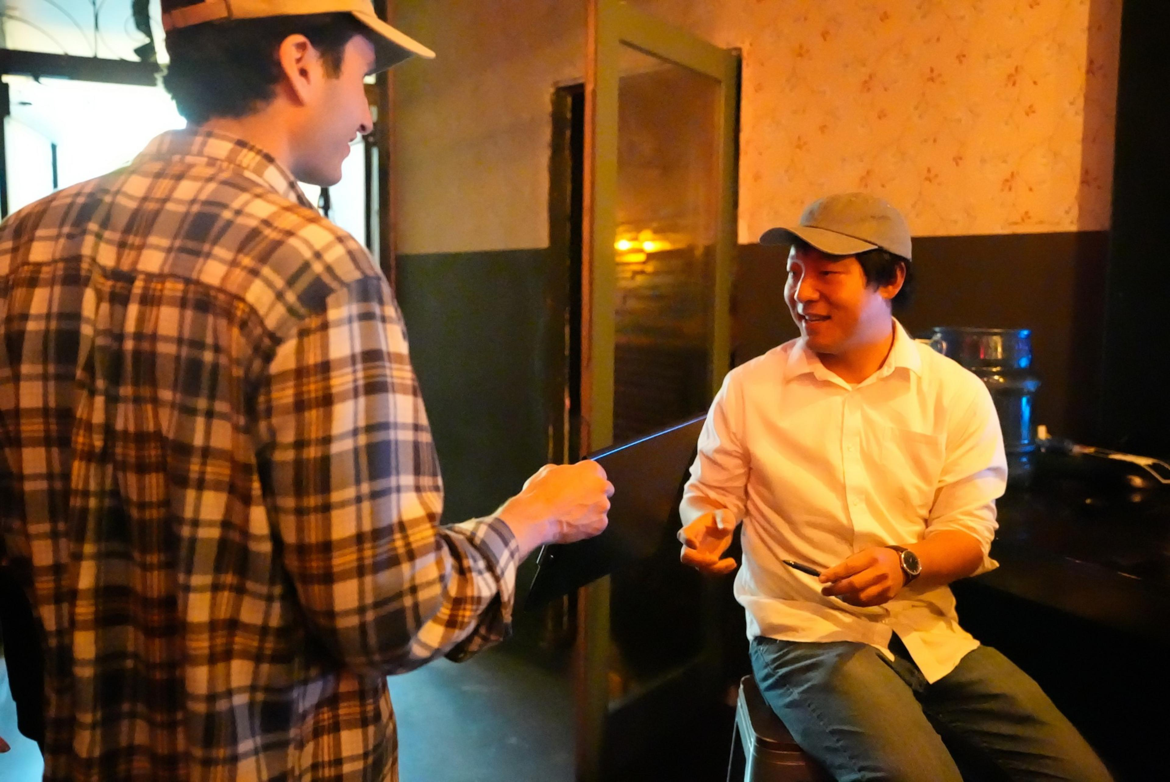 Two man talking at a bar