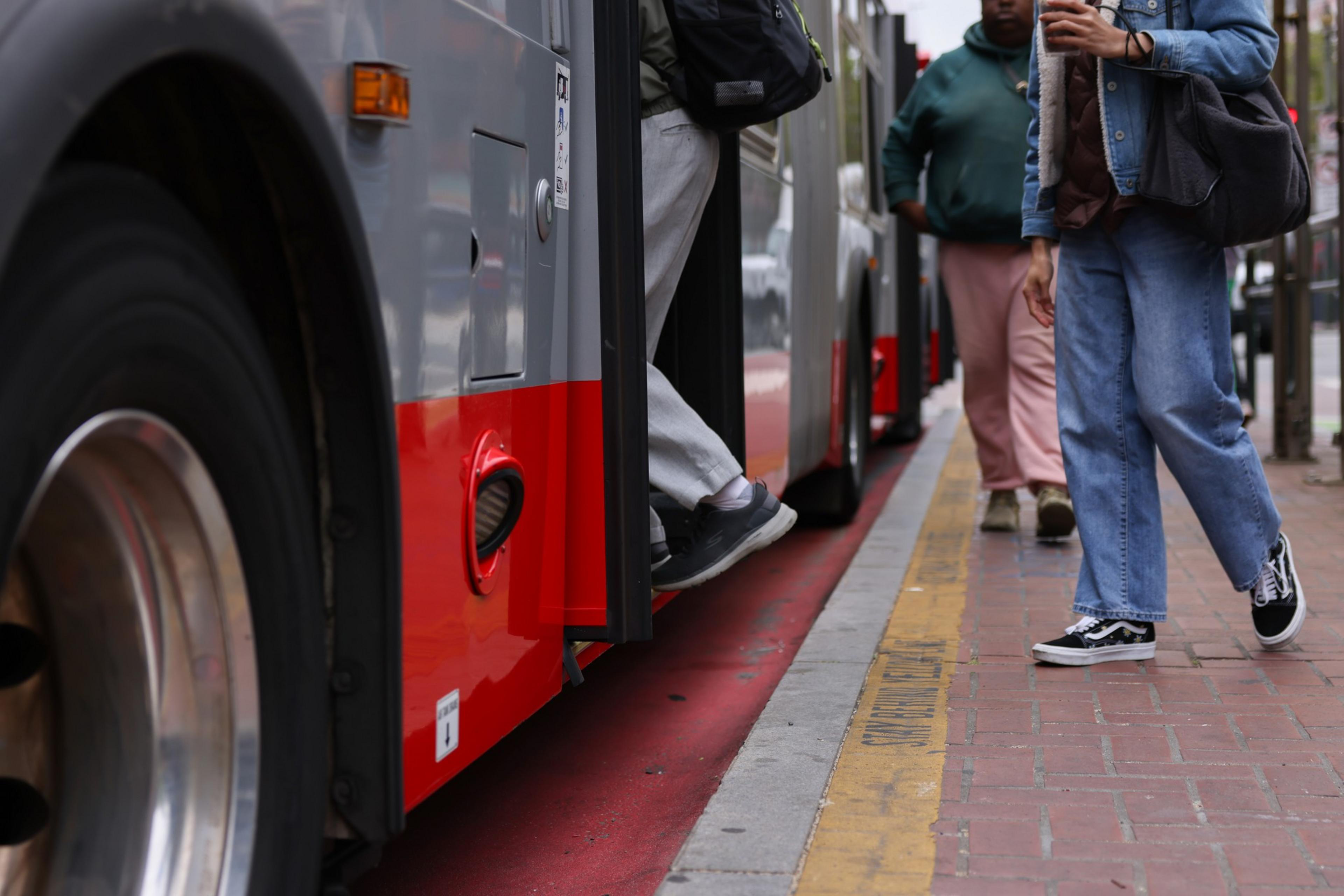 Riders enter a bus.