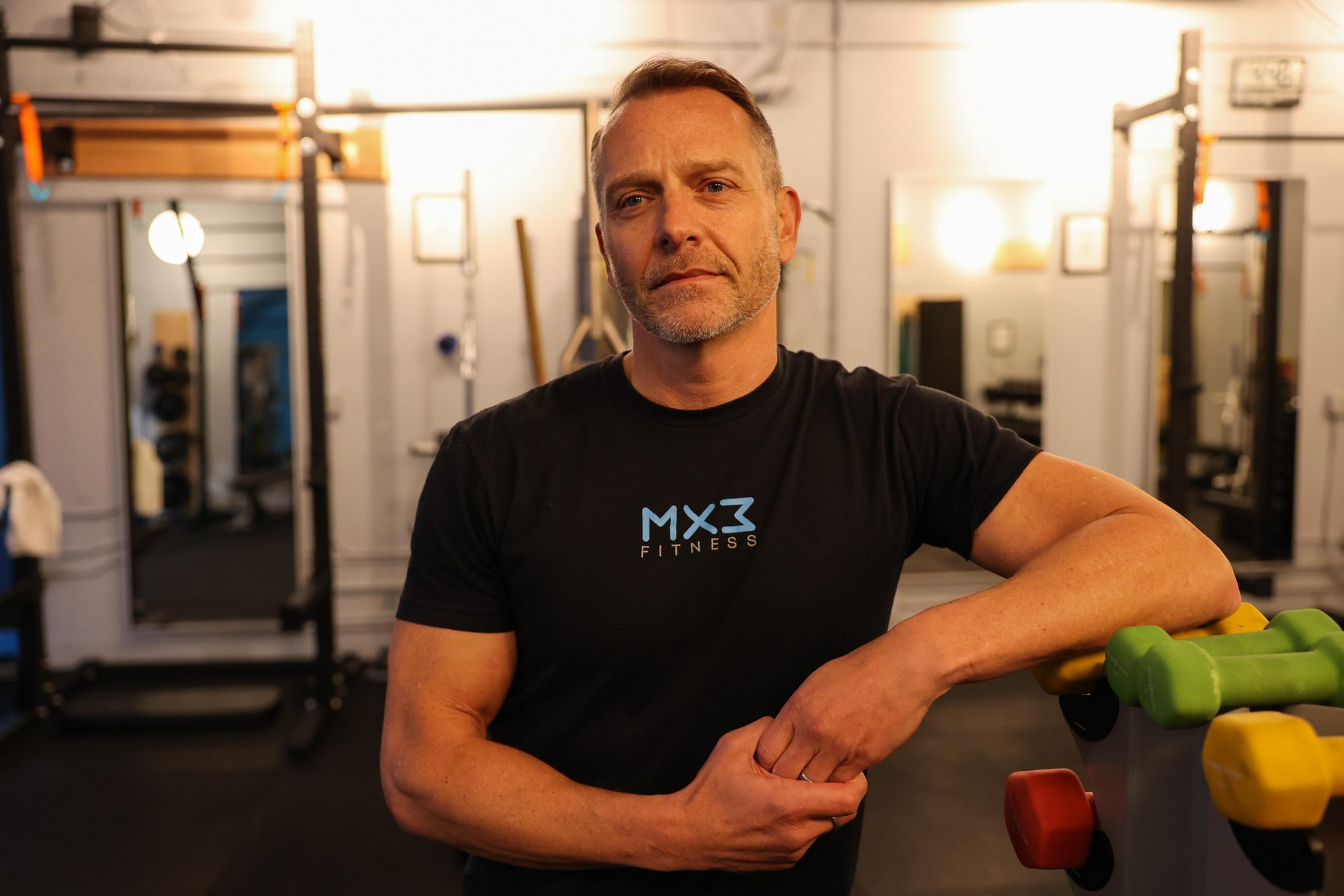 A man poses with weights.