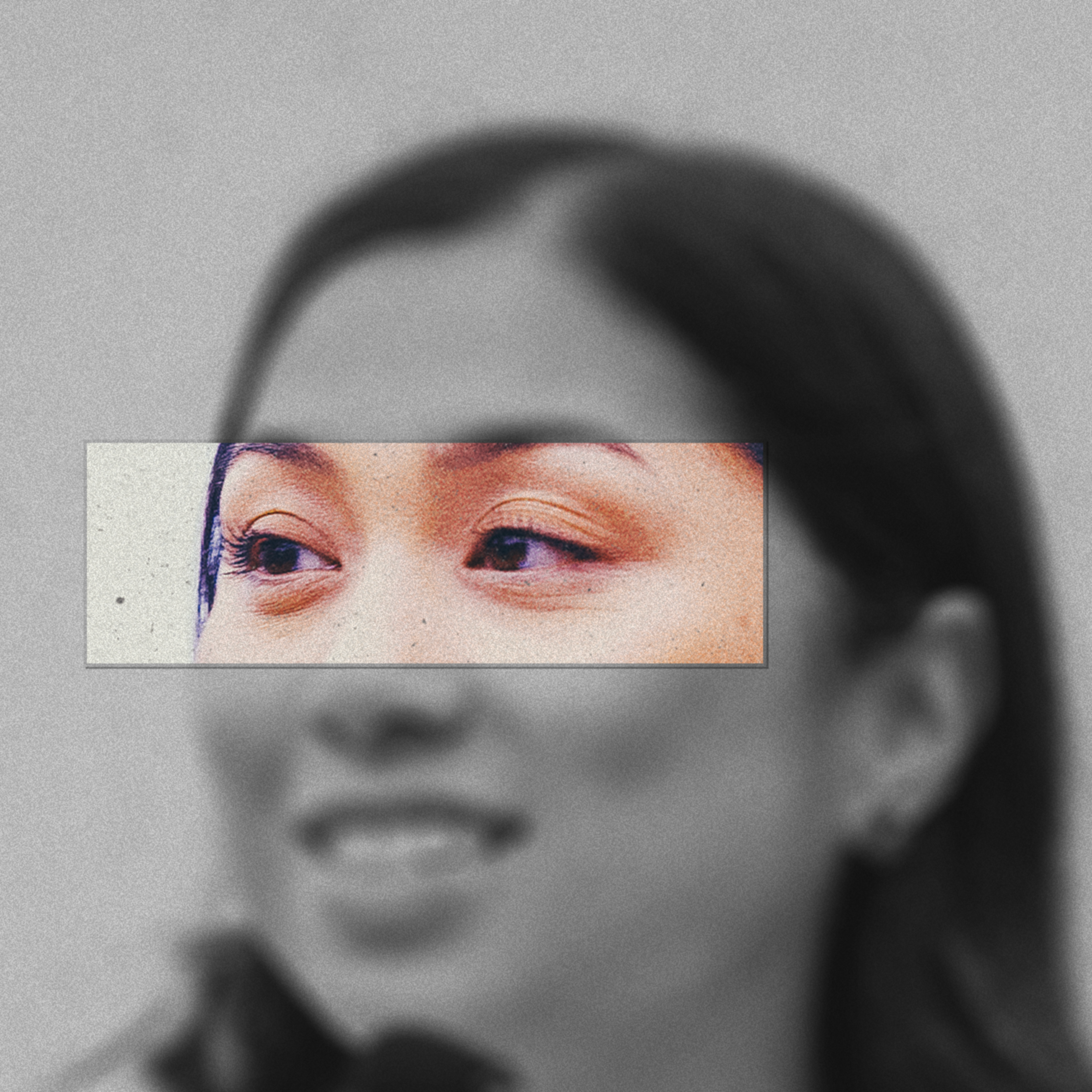 A black-and-white portrait of a smiling woman with long hair includes a color close-up of her eyes framed in a small rectangle over her face.