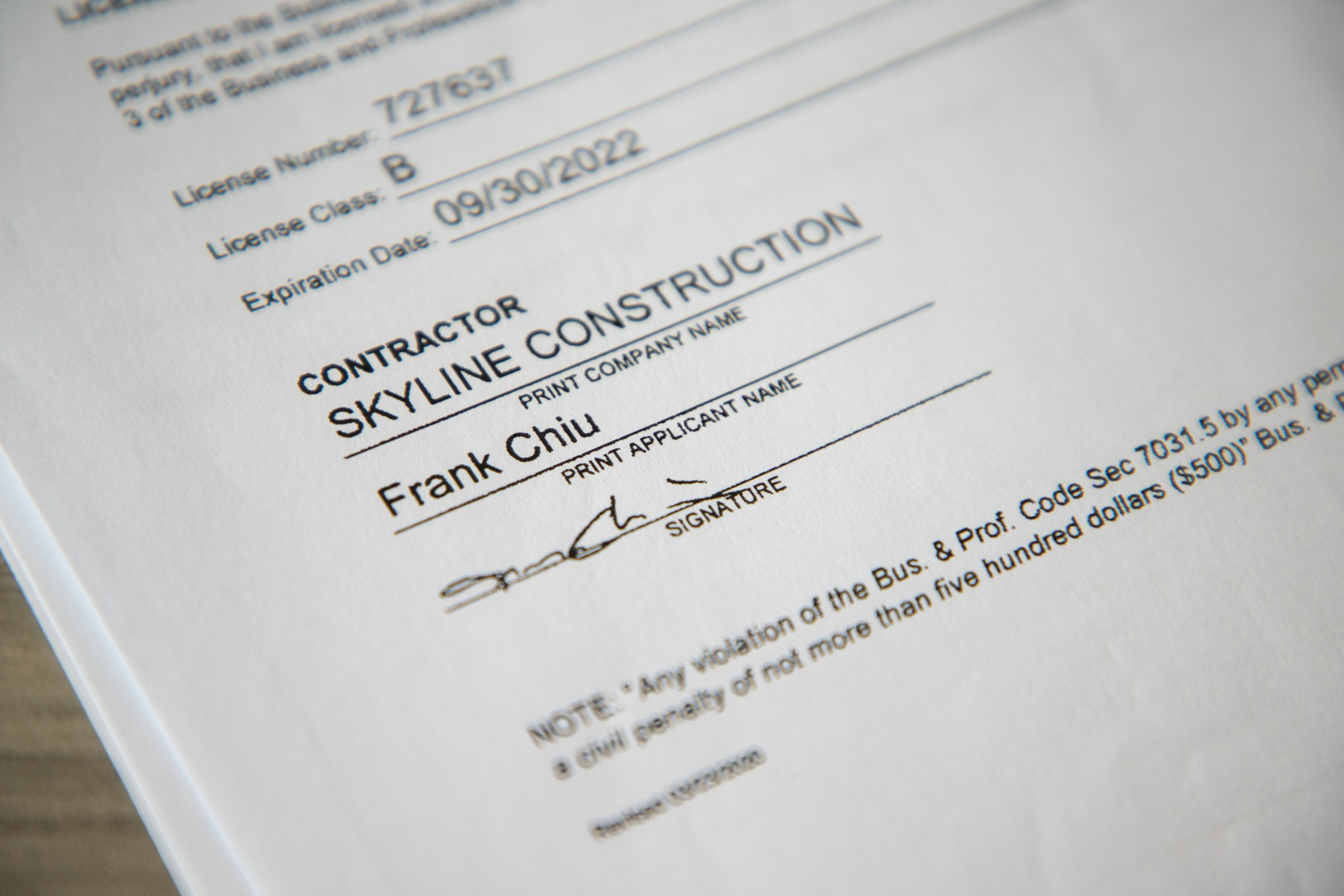 A close-up of a document with a company name and a signature.