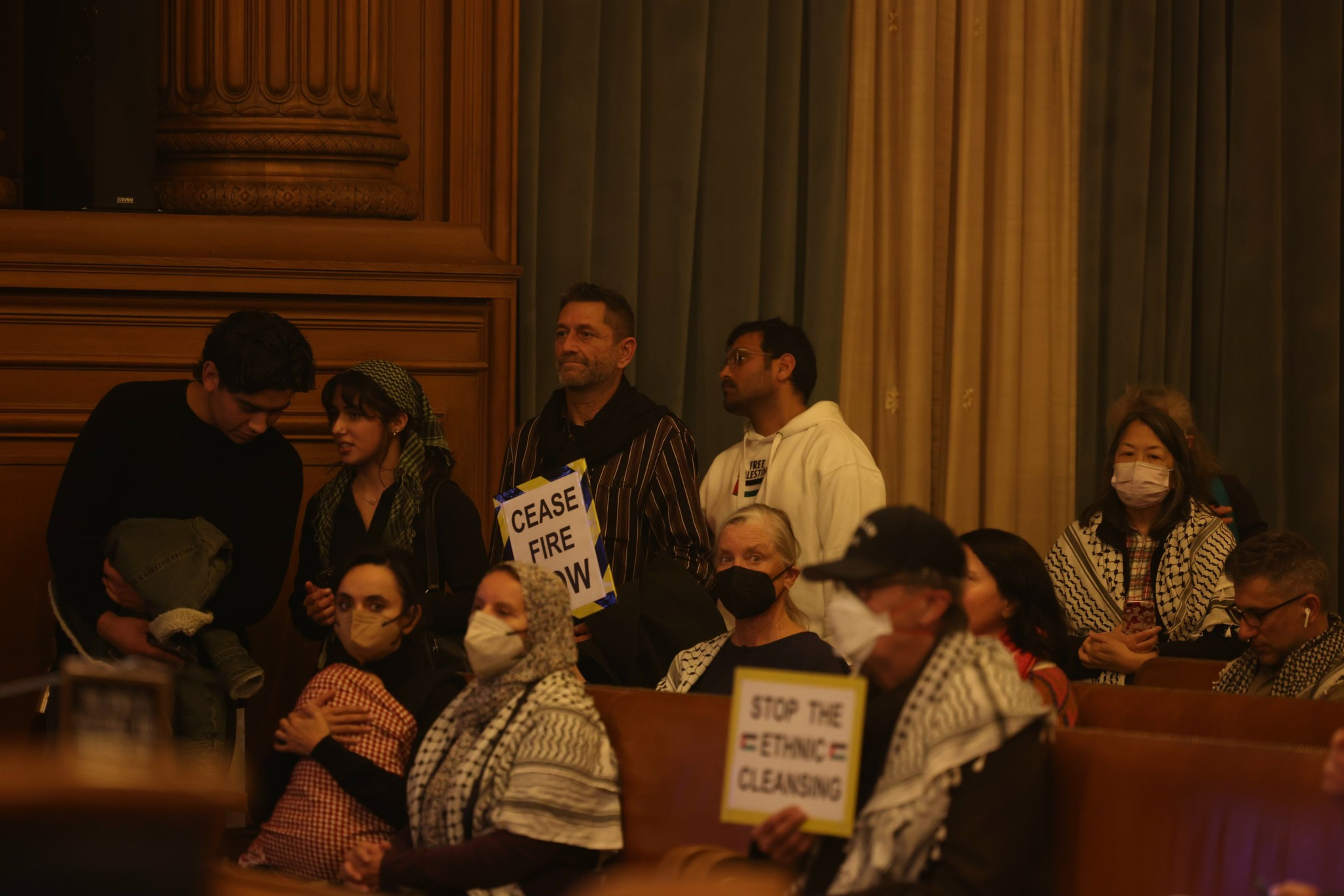 People wait in line to to speak to the Board of Supervisors meeting.