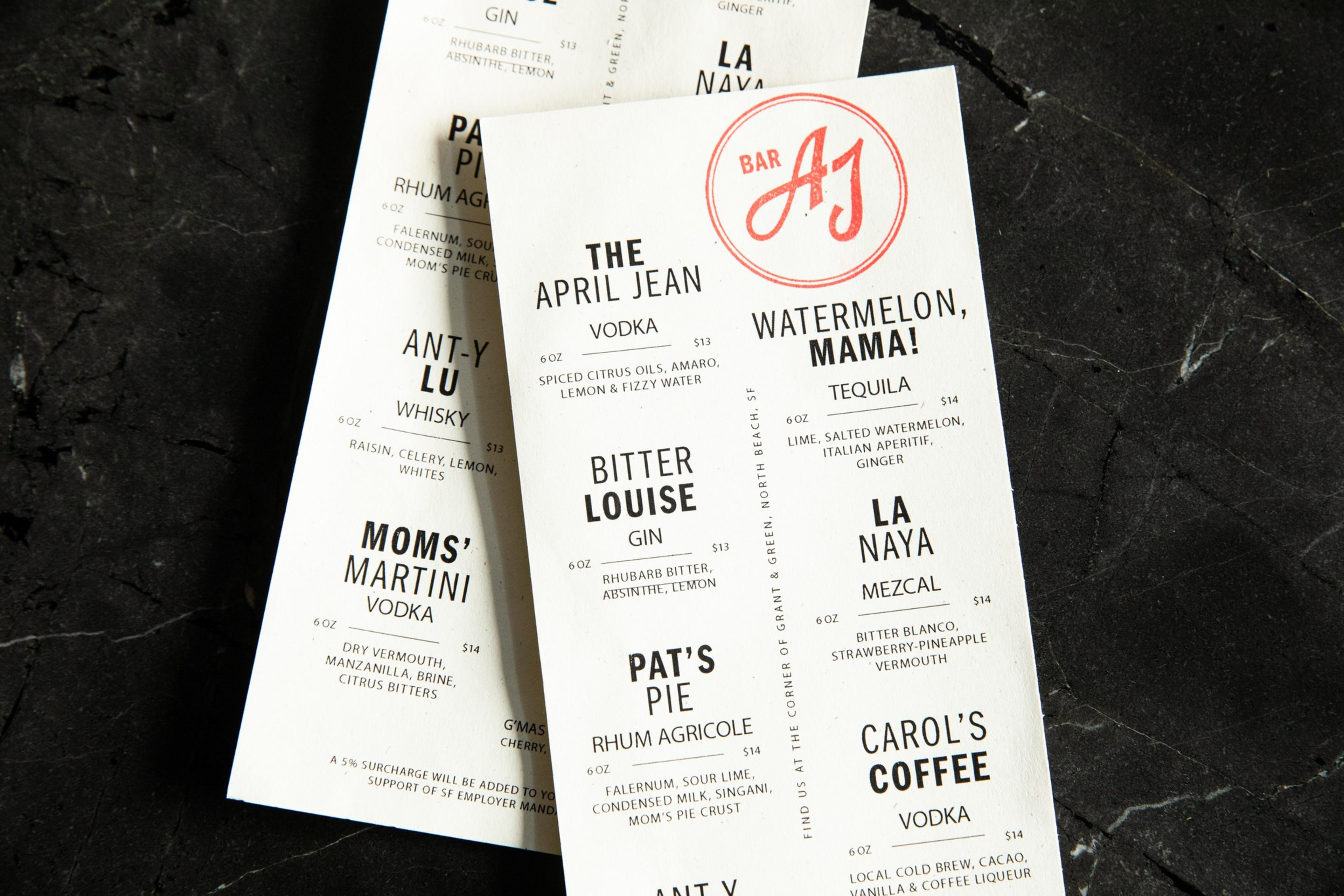 The image shows two overlapping cocktail menus listing various drinks with ingredients and prices, featuring names like &quot;The April Jean,&quot; &quot;Bitter Louise,&quot; and &quot;Pat's Pie.&quot;