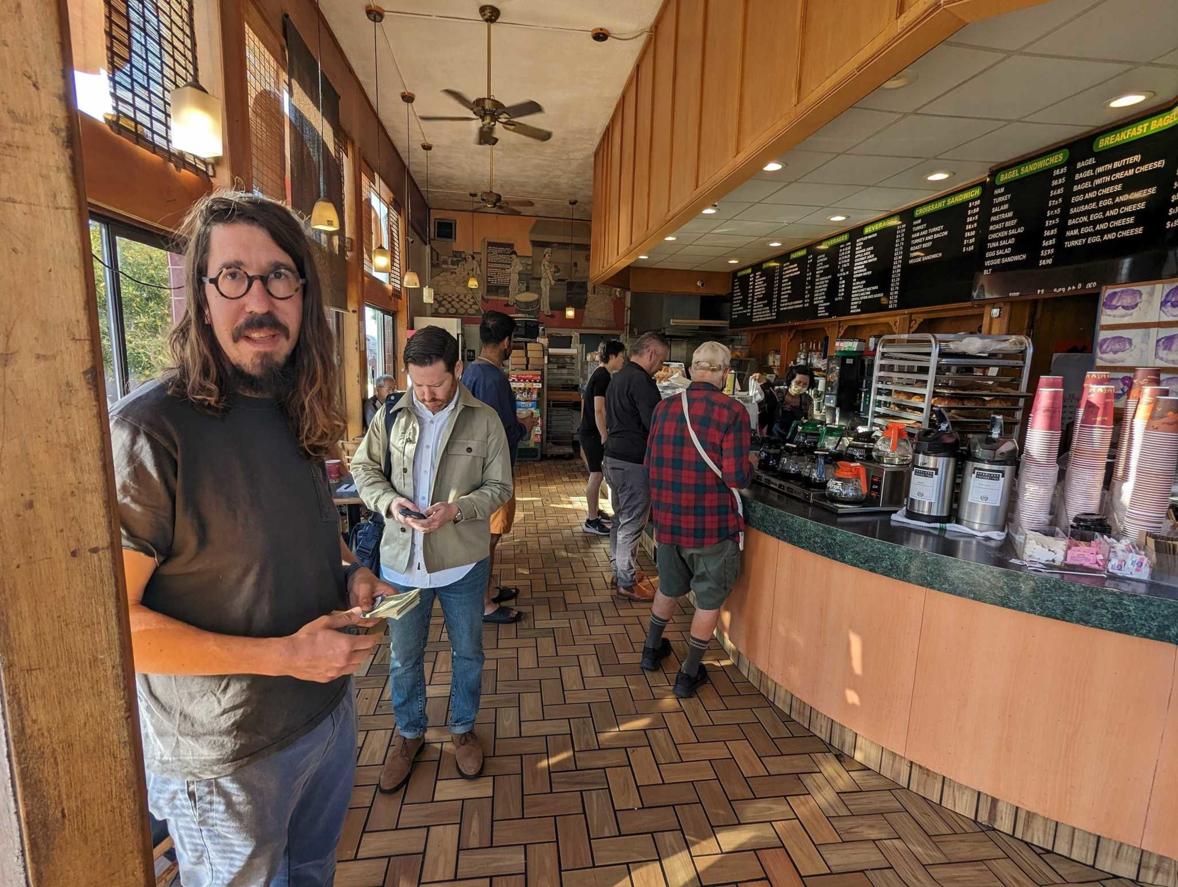 Julian Weisser greeted visitors to Happy Donuts for an hour Wednesday with an offer to pay for customers' doughnuts.