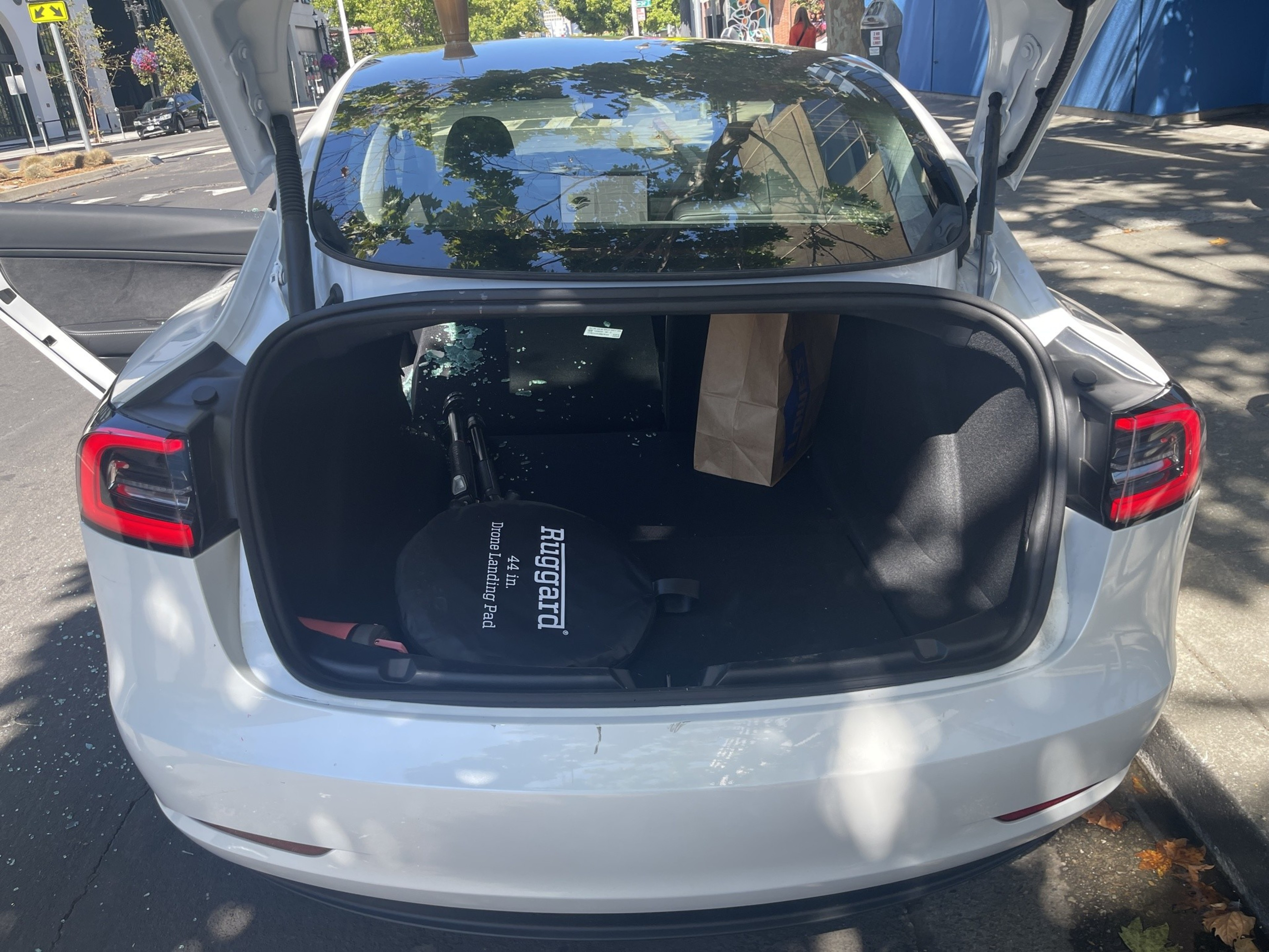 Broken glass litters the inside of a rented and broken-into 2023 Tesla Model S on Broadway near 24th Street in Oakland last Saturday.