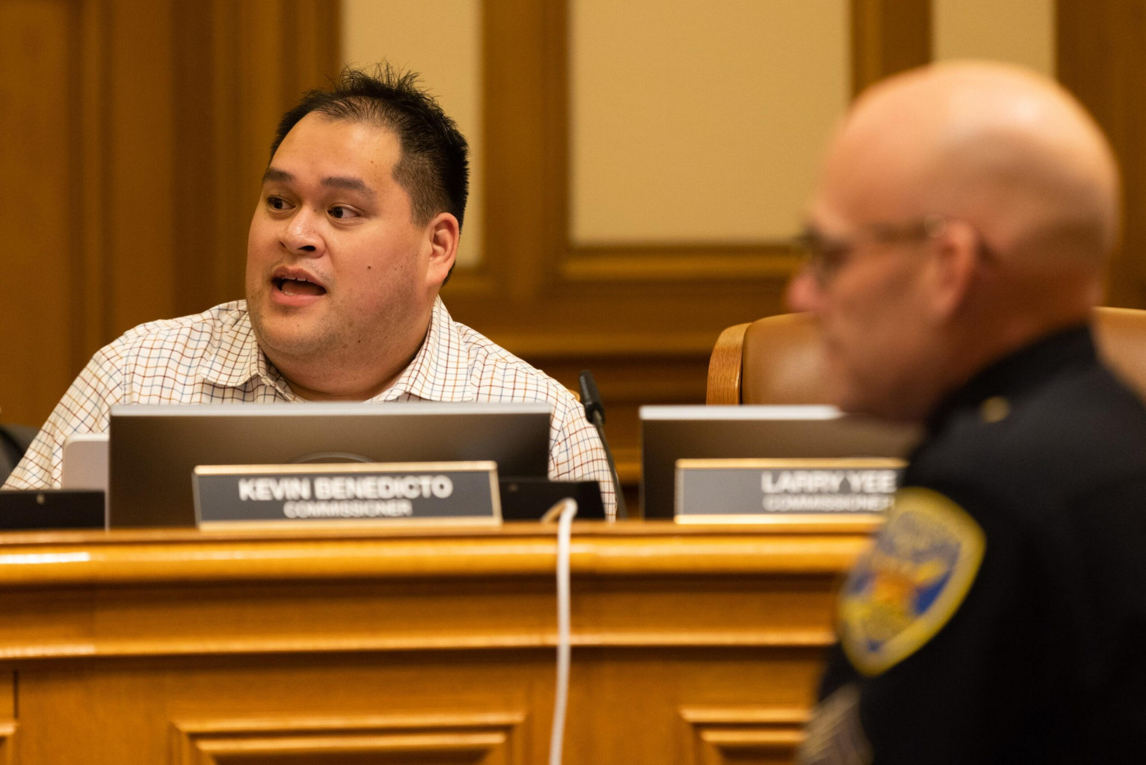 A police commissioner speaks at a meeting.