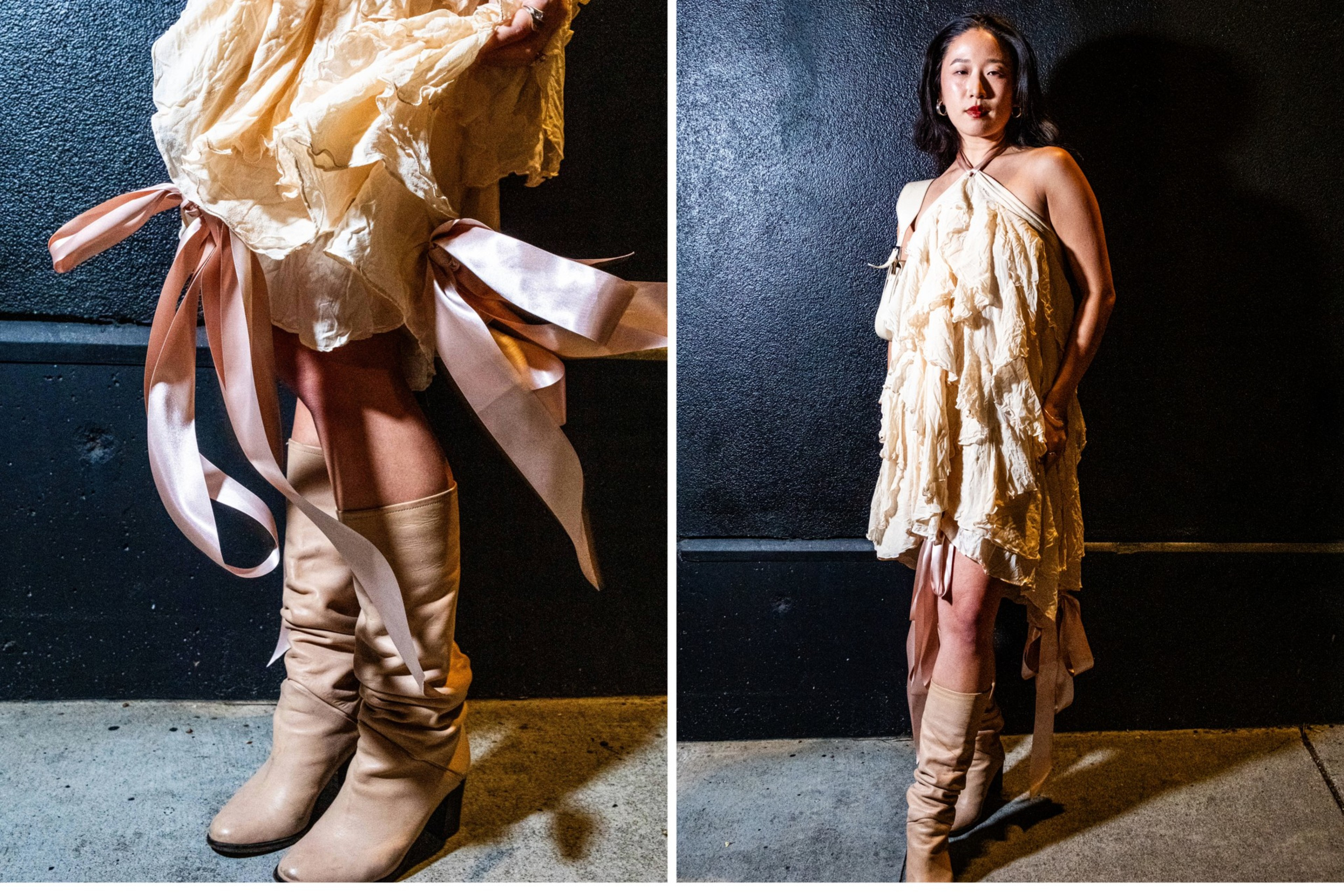 A person stands against a dark wall wearing a textured cream dress with pink ribbons and beige knee-high boots. The setting appears urban, with concrete flooring.