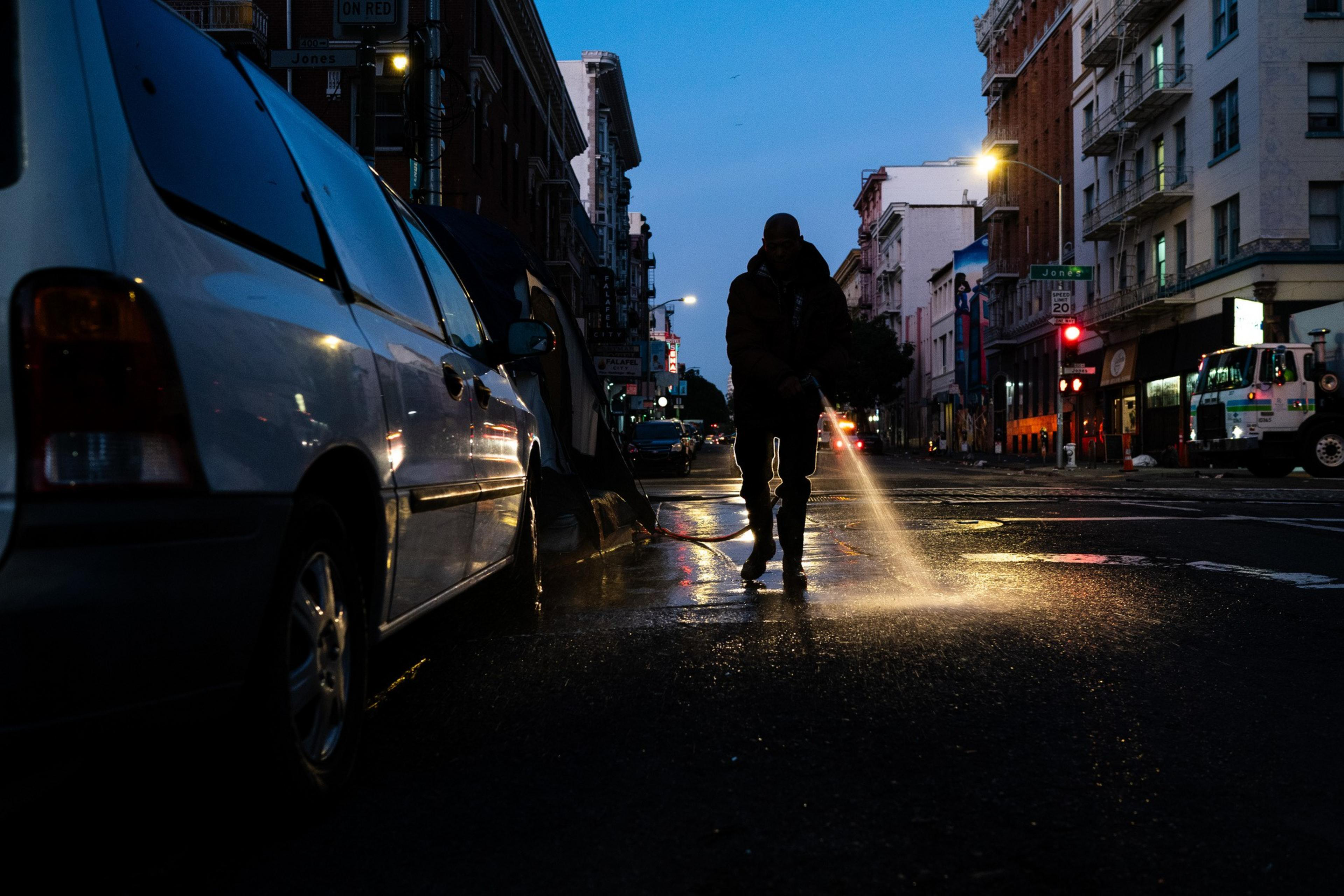 A man with a house watches the street in the morning.