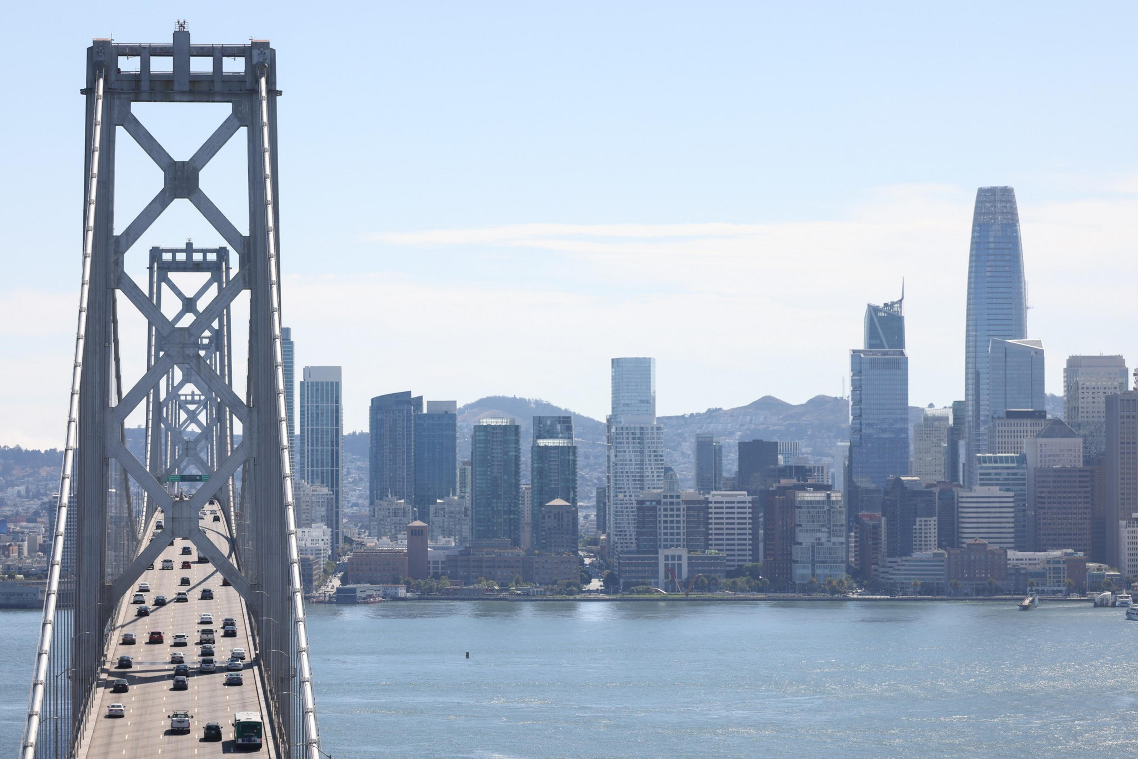 A bride with cars driving over is on the left and the San Francisco byline in the background is on the right