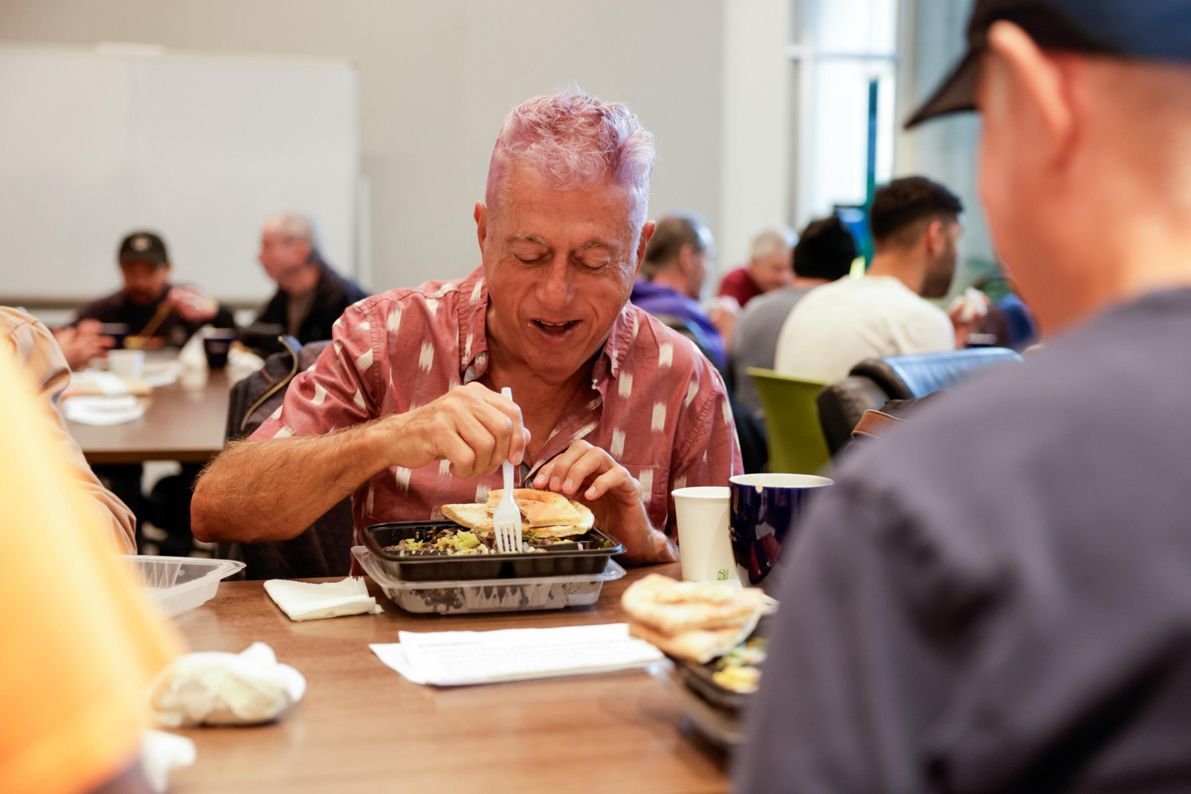 A member of the Curry Senior Center chats with fellow members during Lunch Bunch