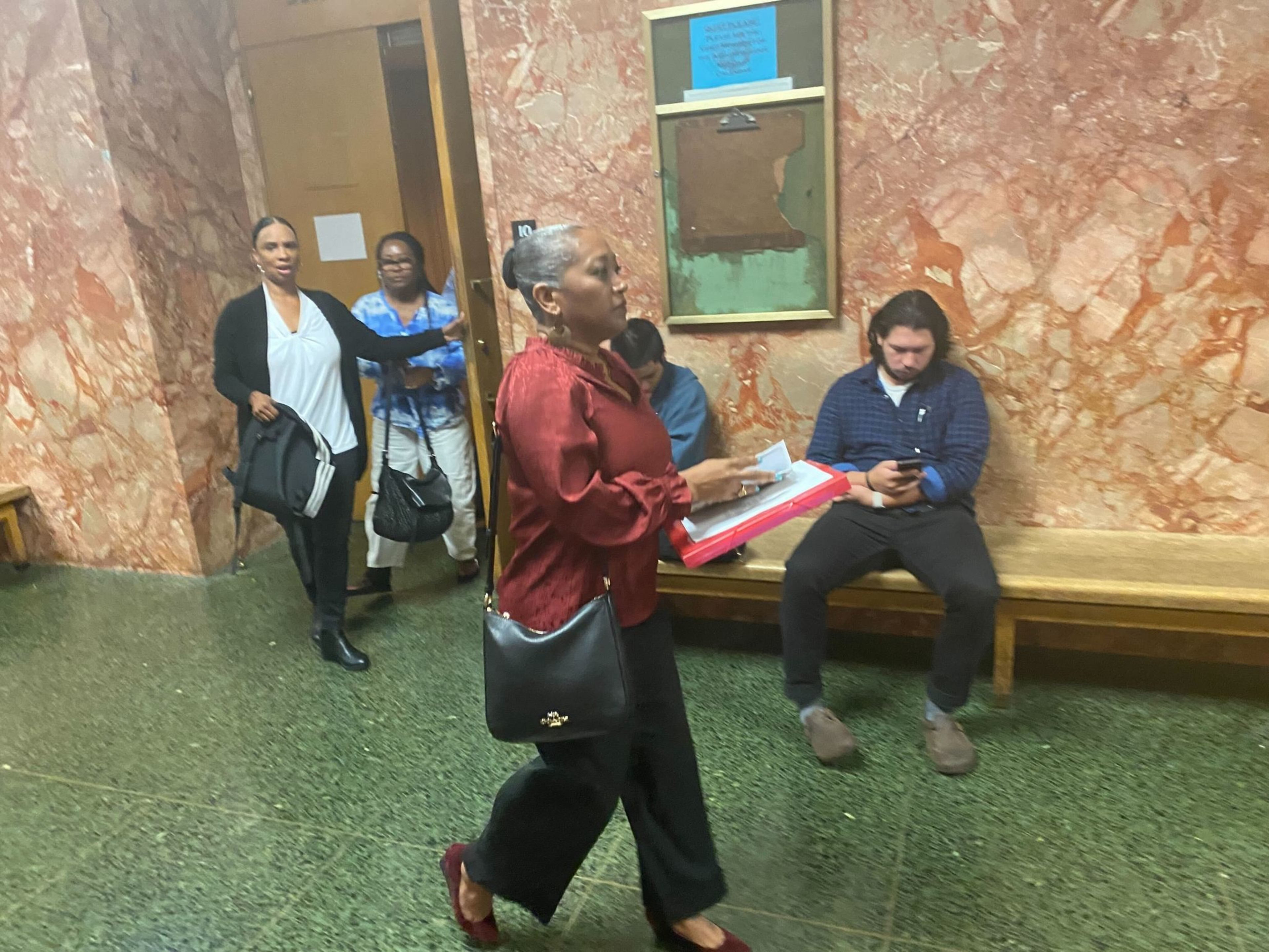 A woman walks out of court.