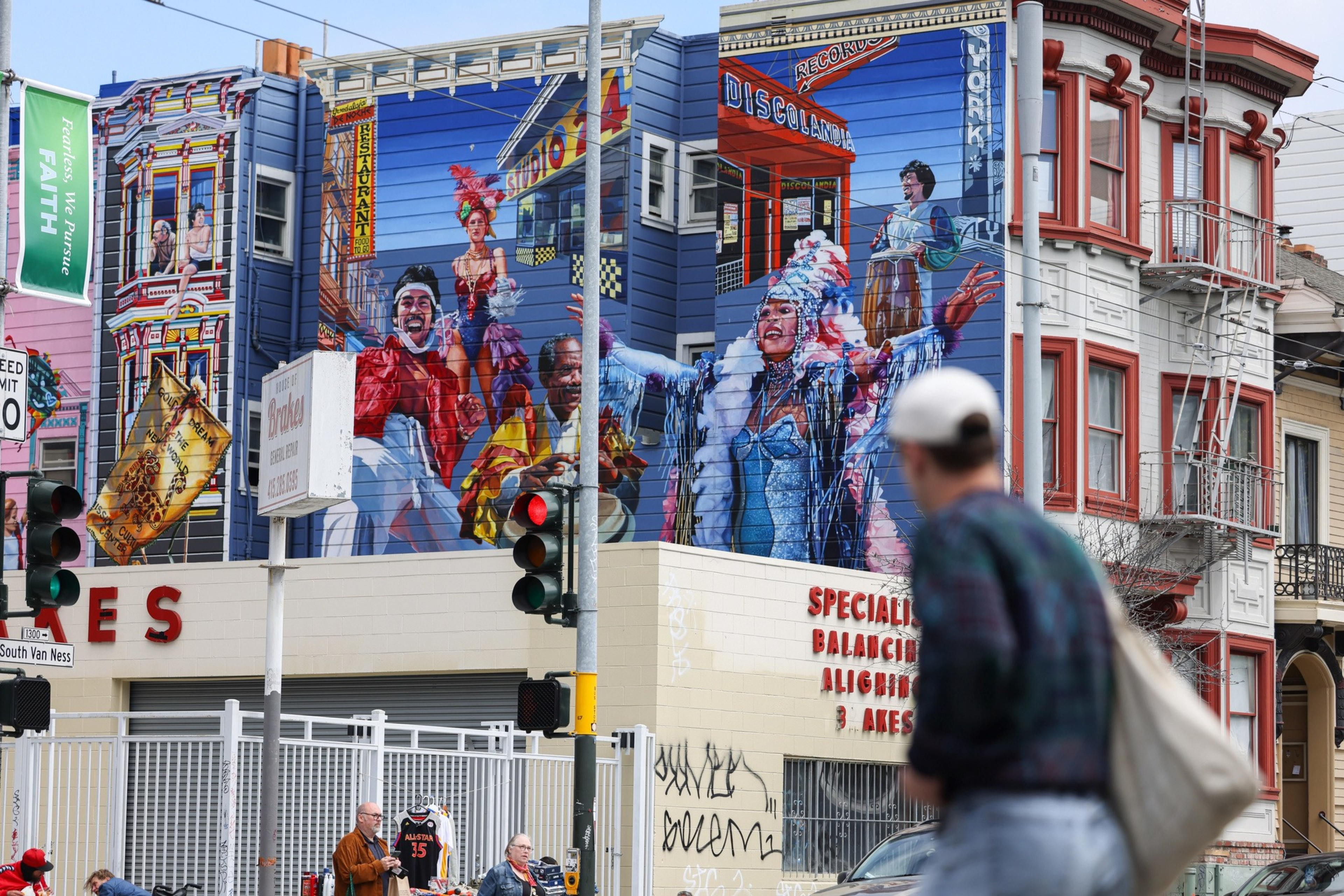 Colorful painting of carnival scene on side of apartment building