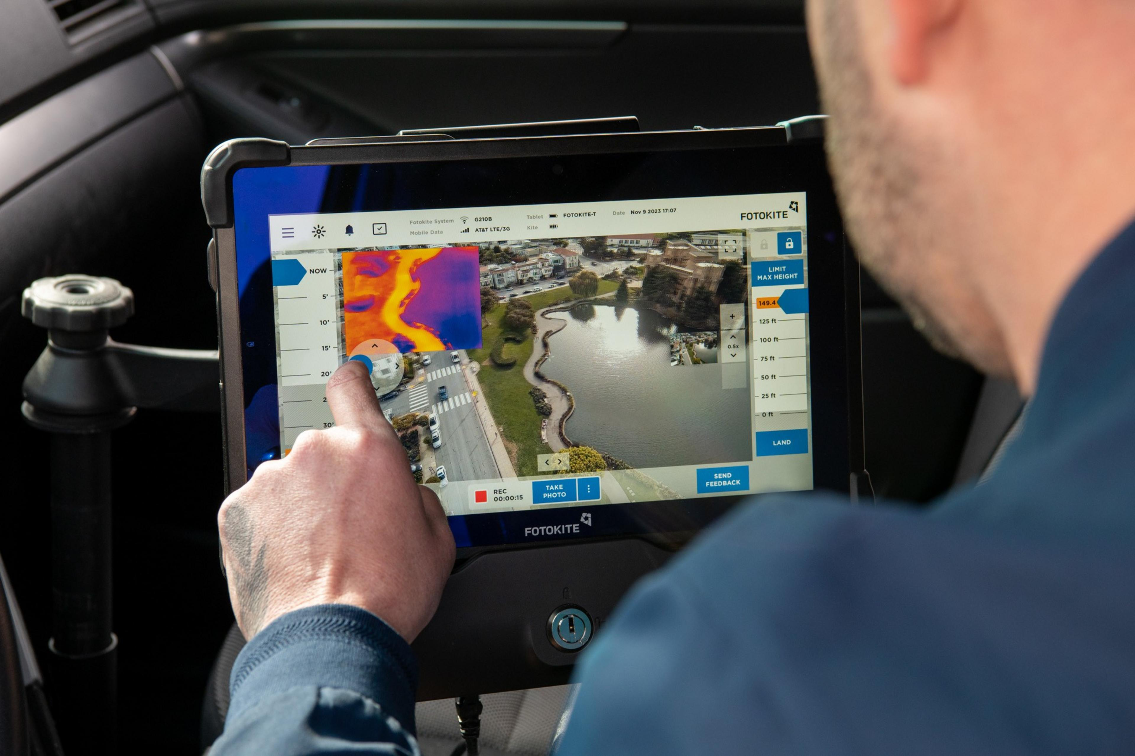A person is using a tablet displaying a map and thermal image.