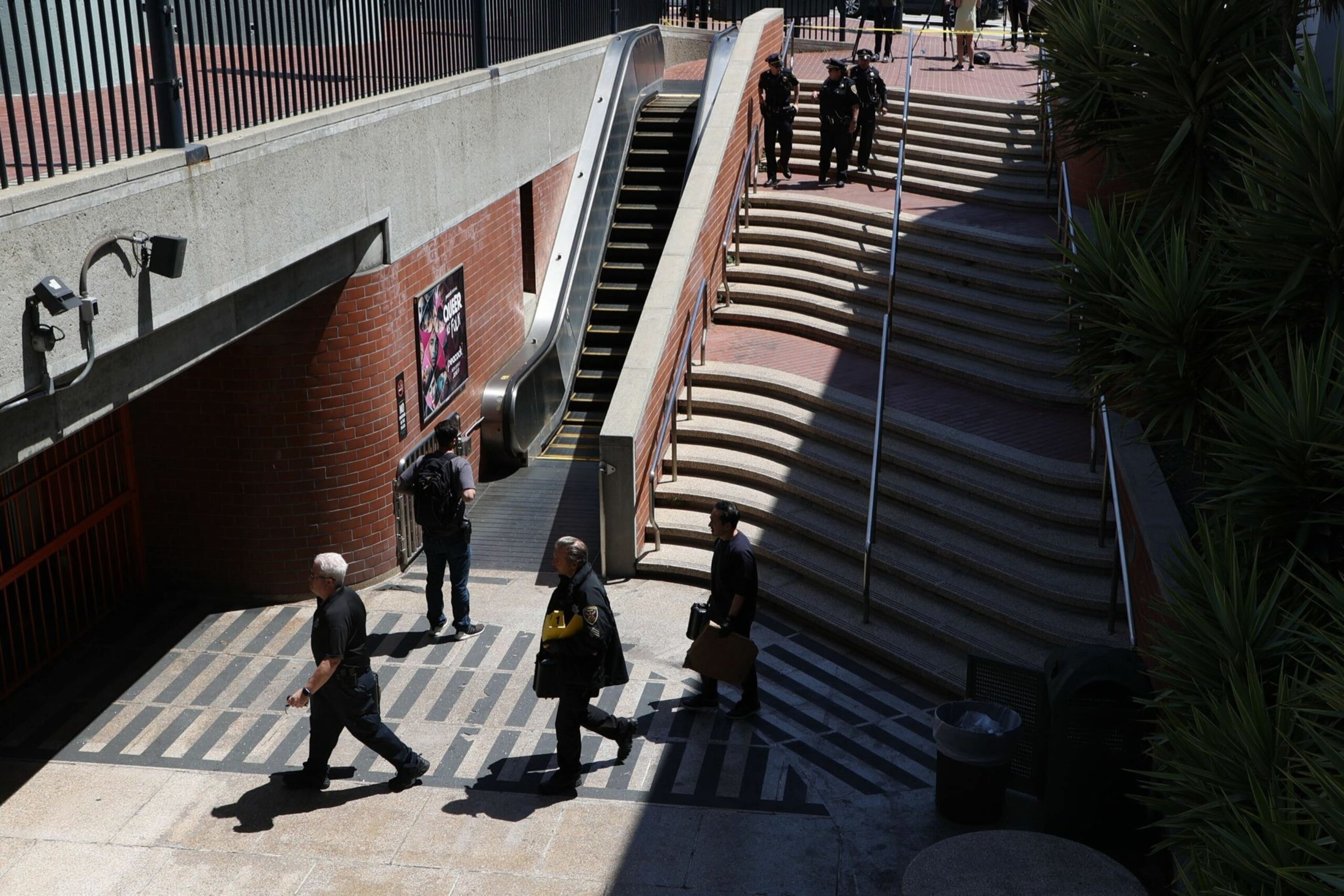 San Francisco Police Officers talk outside the Castro Muni station at Harvey Milk Plaza on Wednesday, June 22, 2022. Following a shooting on a Muni train, SFPD has confirmed that one victim has died and the second sustained non-life threatening injuries. | Camille Cohen/The Standard